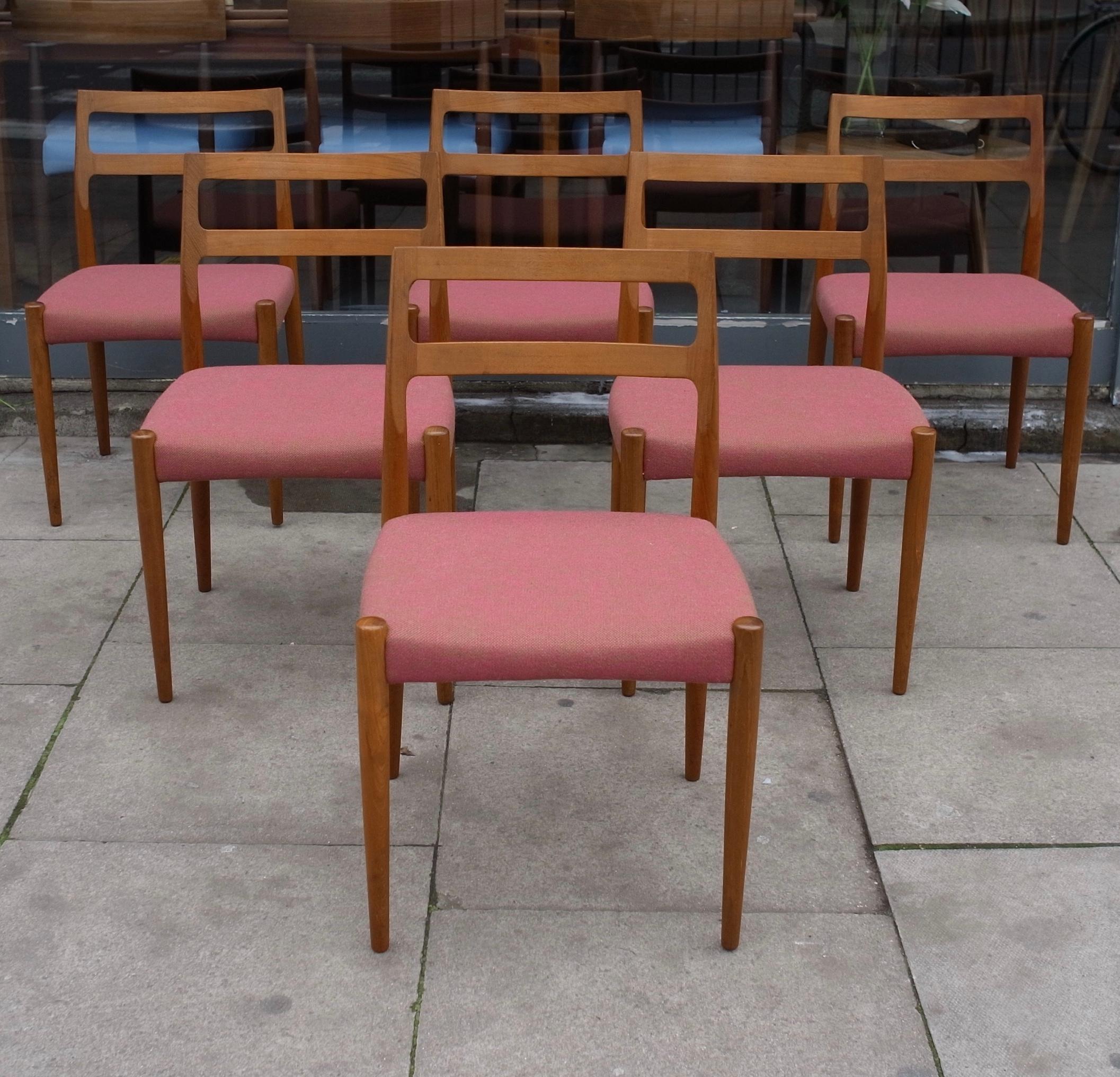A very stylish, elegant and rare set of six 1960s Danish dining chairs, designed by Johannes Andersen and produced by Uldum Mobelfabrik. Created in solid Teak, and recovered in a redis pink coloured, quality textile. These classic and high quality