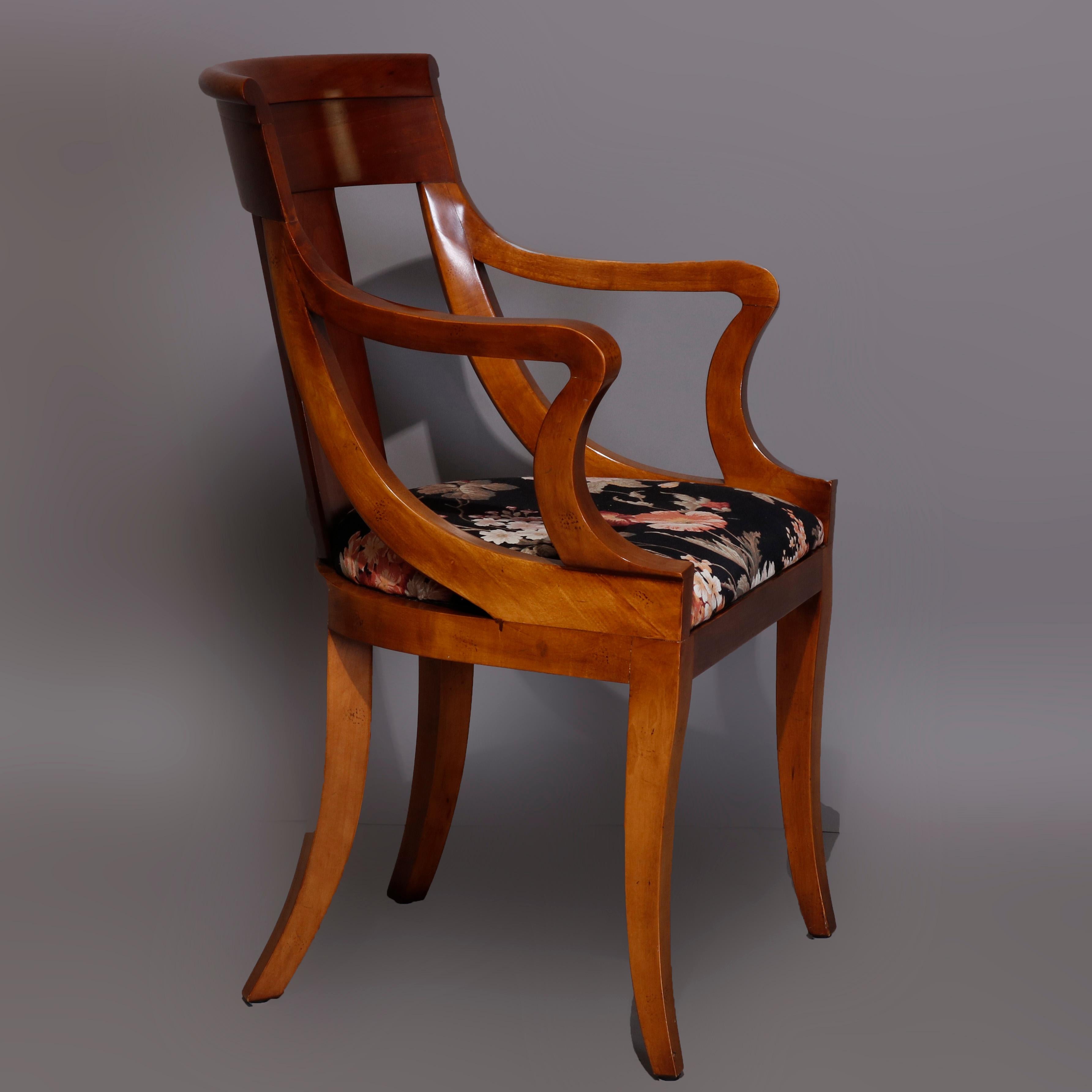 A vintage set of six gondola dining chairs by Baker offer flame mahogany construction with curved slat backs having stylized scroll crest surmounting upholstered seats and raised on squared and concave form legs, set includes two armchairs and four