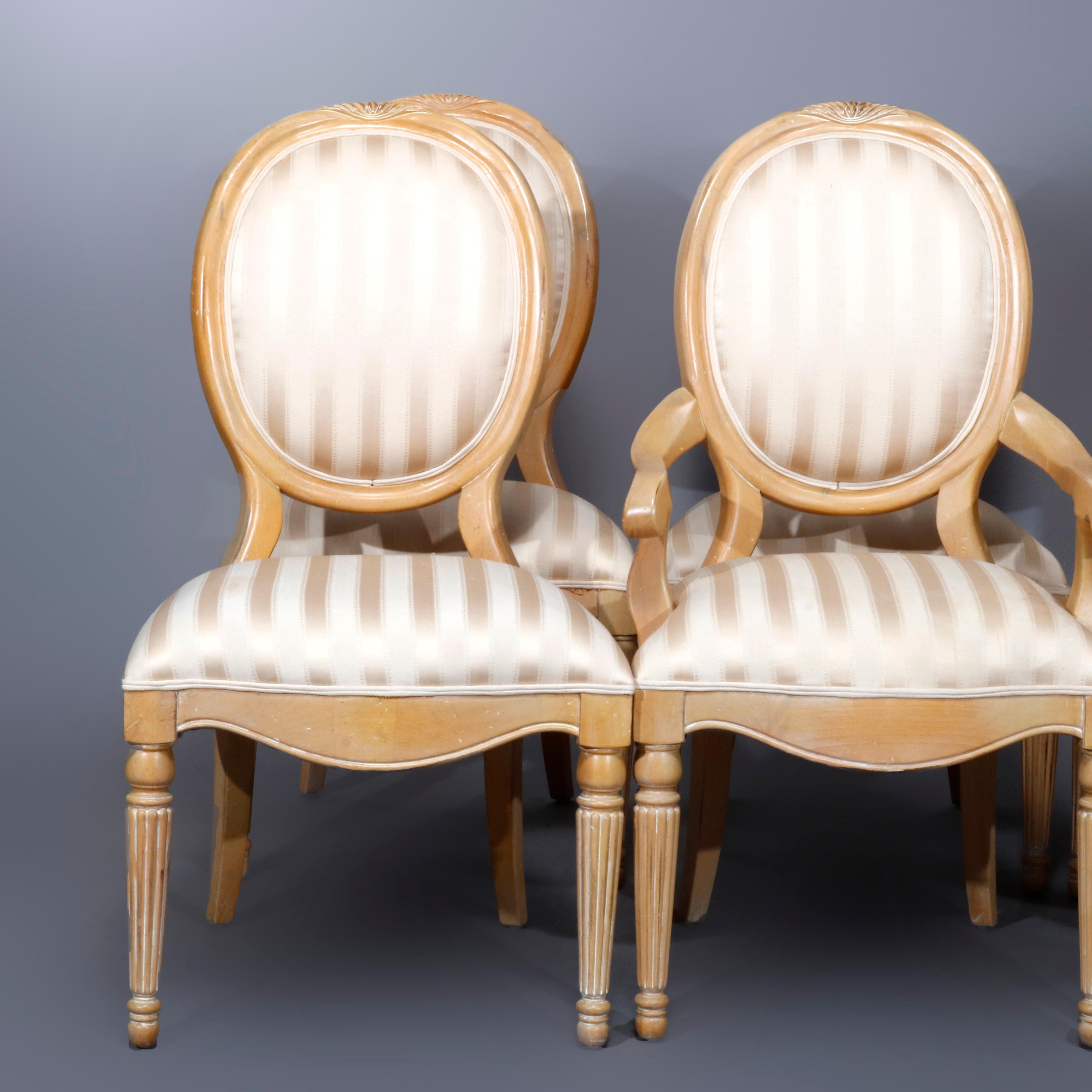 A vintage set of 6 French Louis XVI style dining chairs includes two armchairs and four side chairs and offer white washed wood frames having striped upholstered backs and seats, shaped aprons and raised on turned and reeded legs, 20th