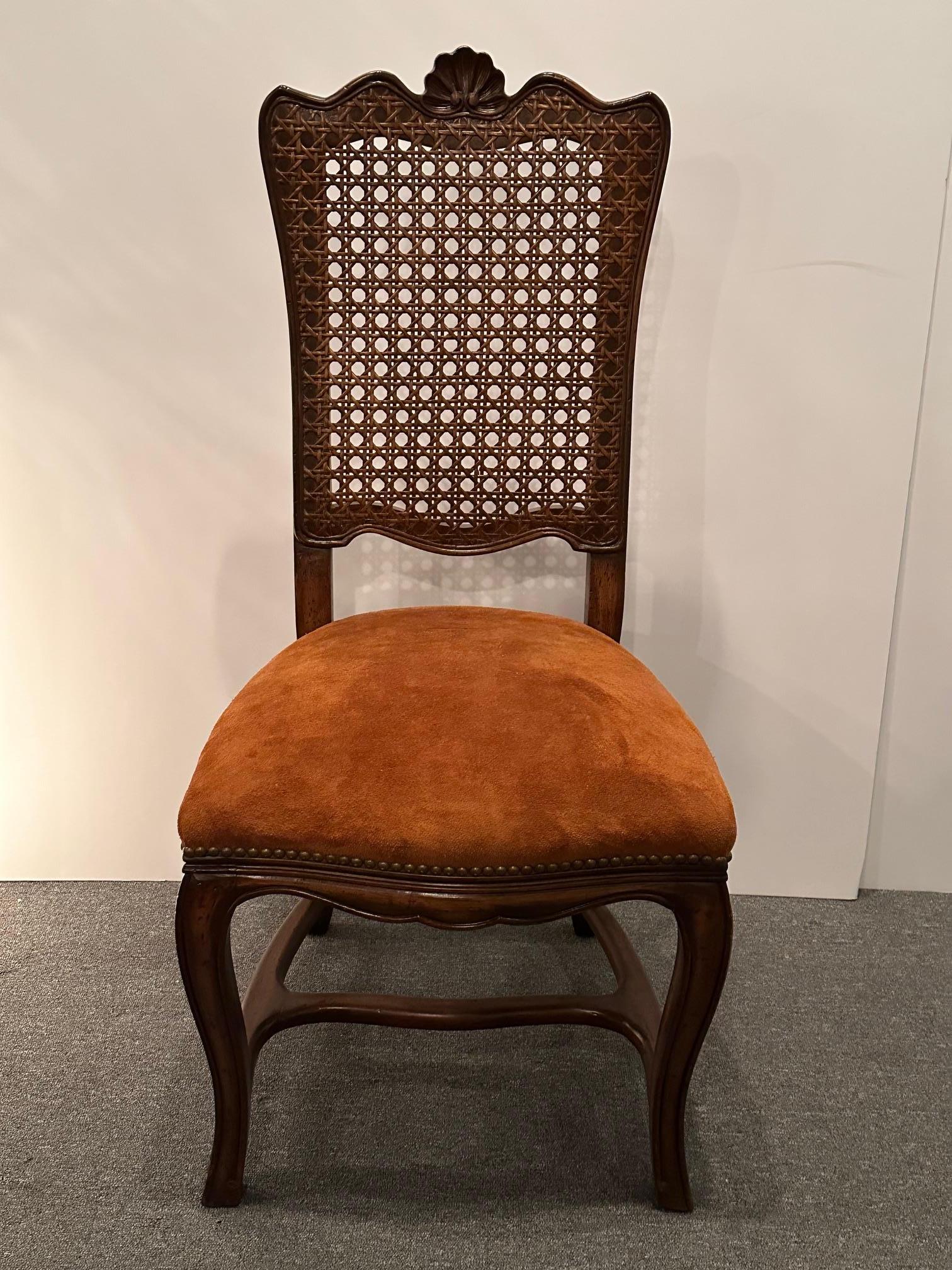 Lovely set of 6 French Provincial style carved mahogany dining chairs having caned backs and suede upholstered seats.