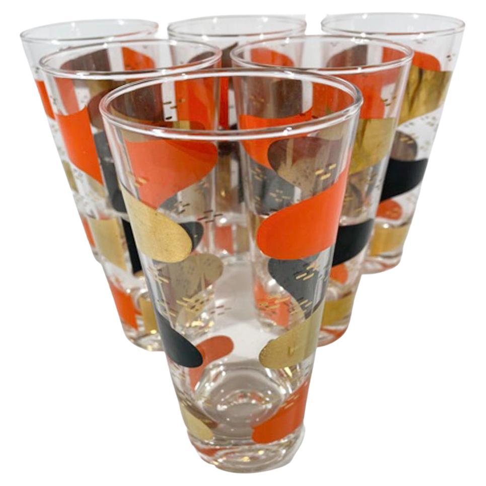 Lot de 6 verres highball de la période Atomic avec des ellipses noires, orange et or parmi un fond de tirets or sur verre transparent.