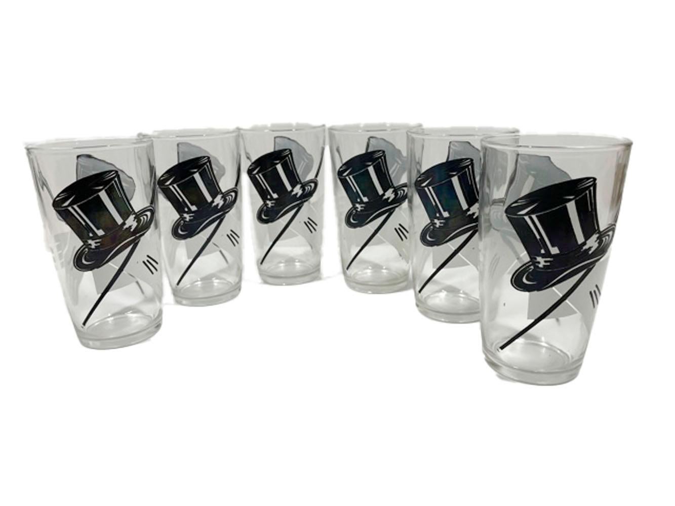 Set of six Art Deco highball glasses by Hazel Atlas decorated with top hats, white gloves and canes in black and white enamel on clear glass.