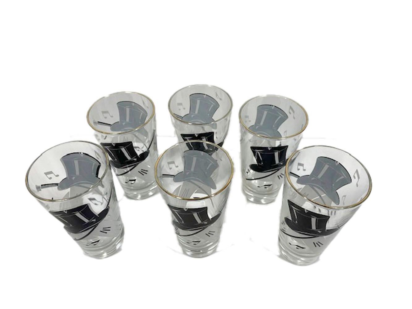 Set of six Art Deco highball glasses by Hazel Atlas decorated with top hats, white gloves, canes and music notes in black and white enamel on clear glass.