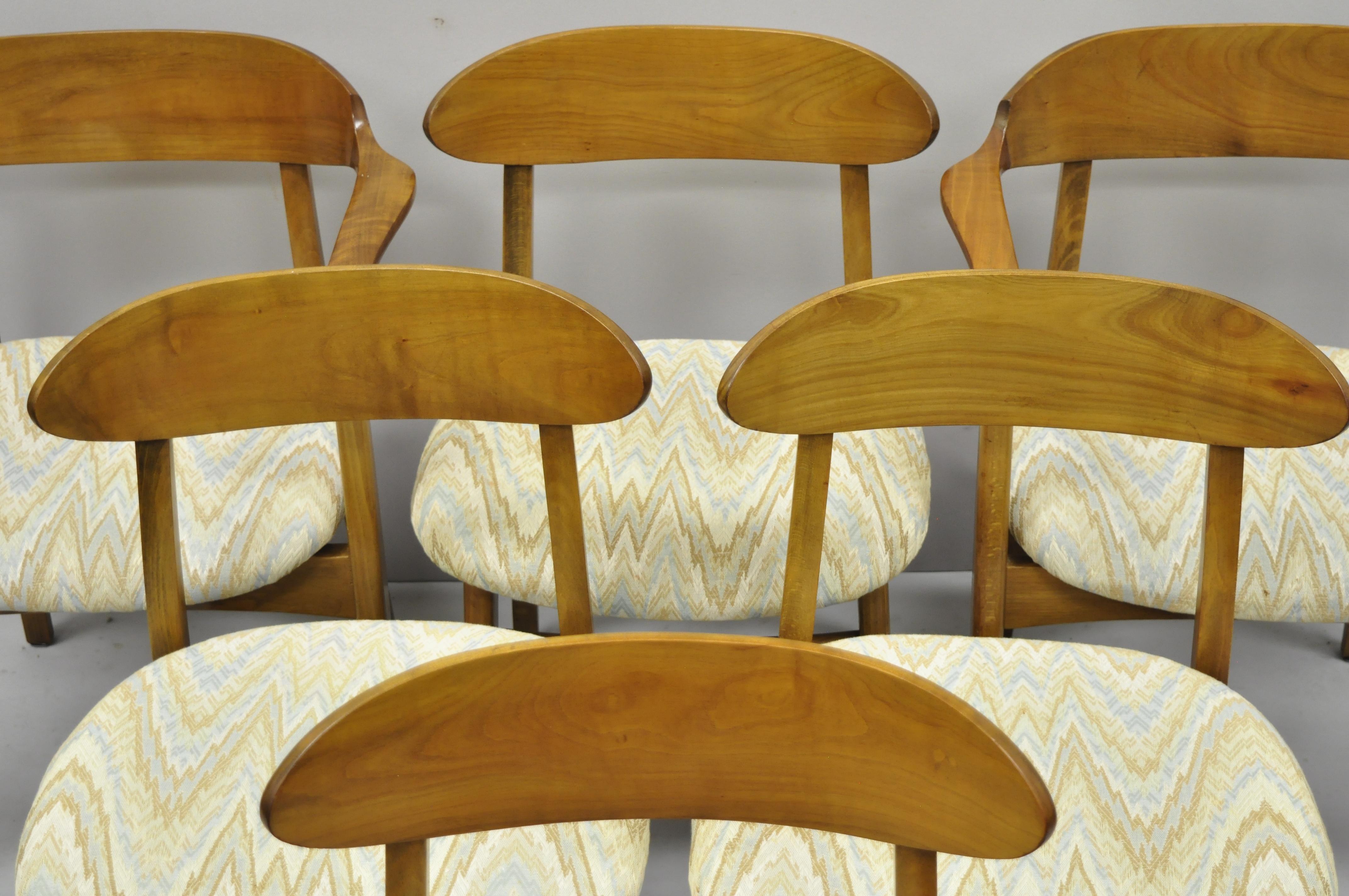 Six vintage Mid-Century Modern sculpted walnut barrel back dining room chairs. Listing features (2) armchairs, (4) side chairs, shapely carved backs, solid wood construction, beautiful wood grain, tapered legs, sleek sculptural form, circa mid-20th