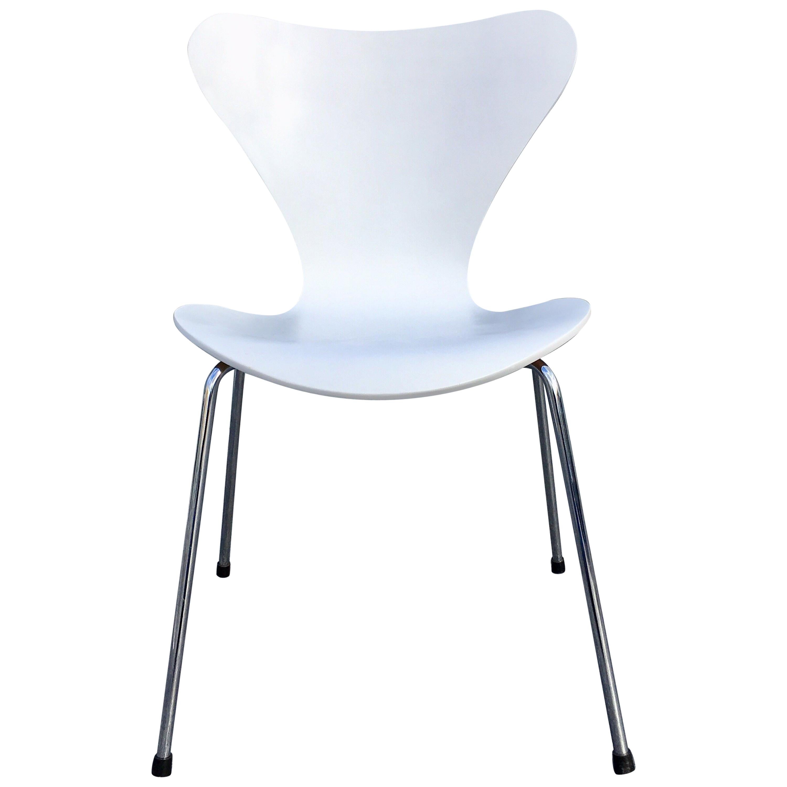 Six original Arne Jacobsen chairs in white, more available.