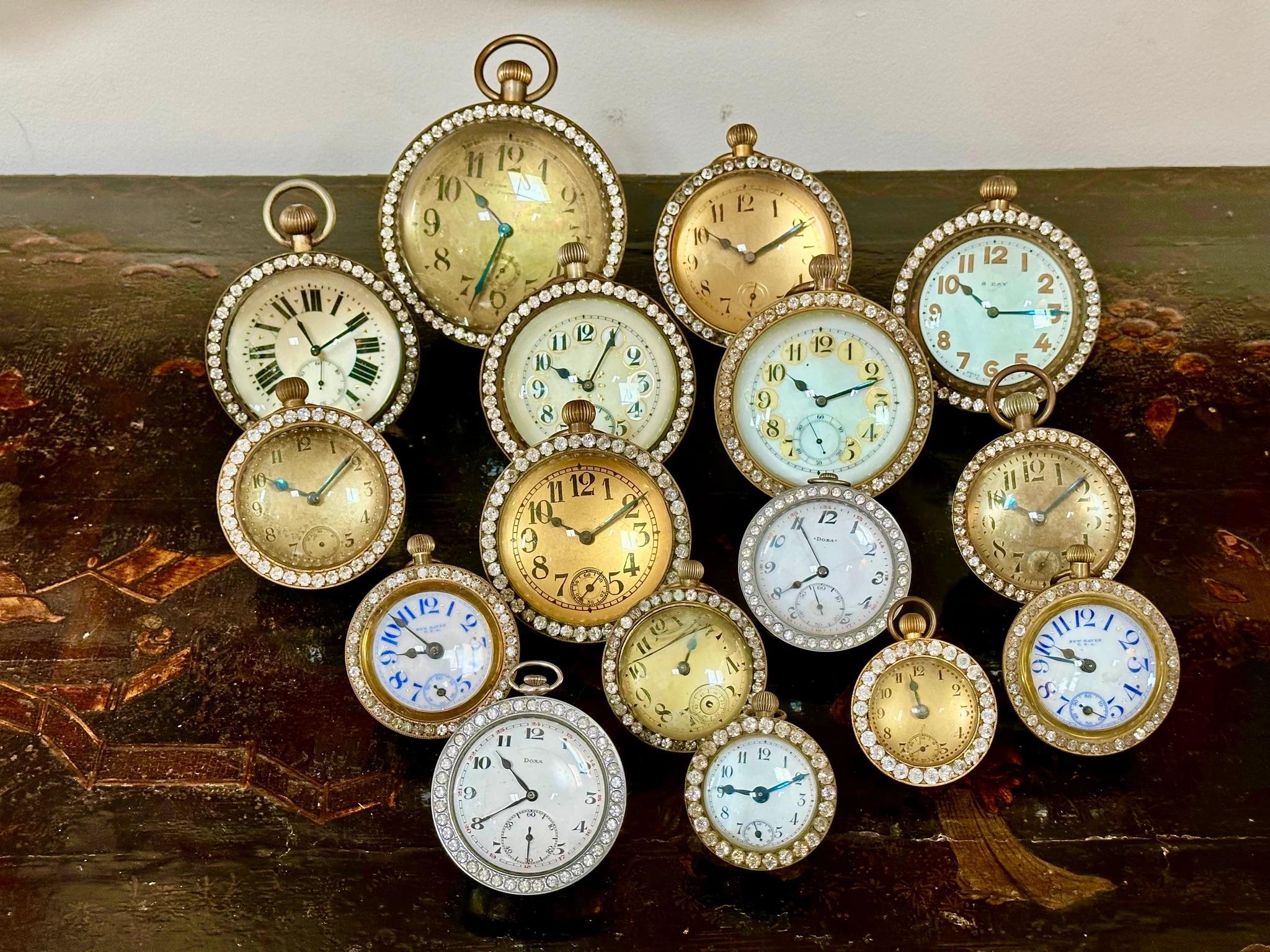 Sixteen ball clocks, all but two having cases of brass and paste diamond, crystal, “jewel” surrounds.  Of varying sizes, styles, and makers, most late 19th century to early 20th century.  One with a kickstand. Most made in France.  3” hi. to 7” h.