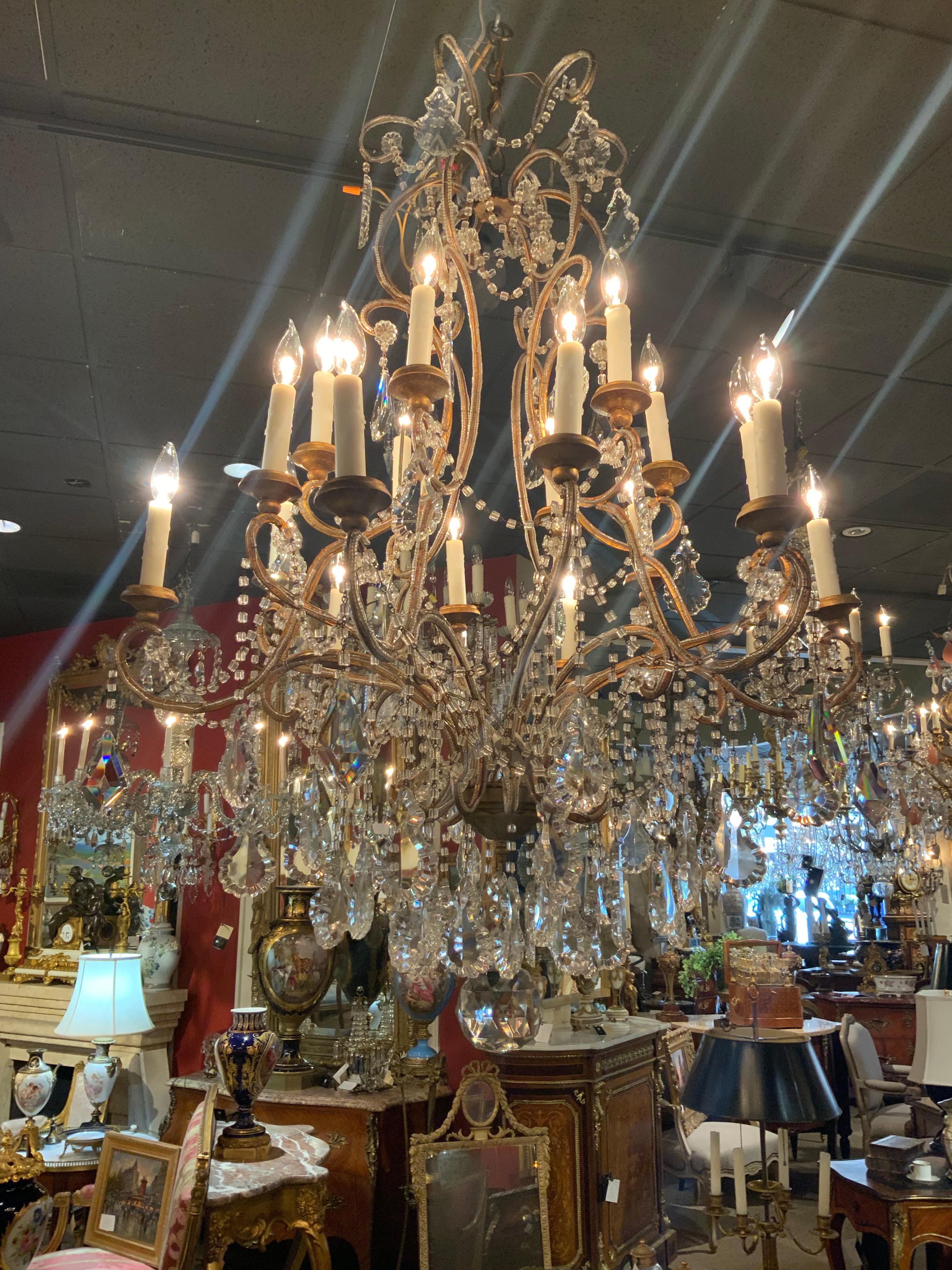 Metal Sixteen light beaded and gilt metal chandelier  For Sale