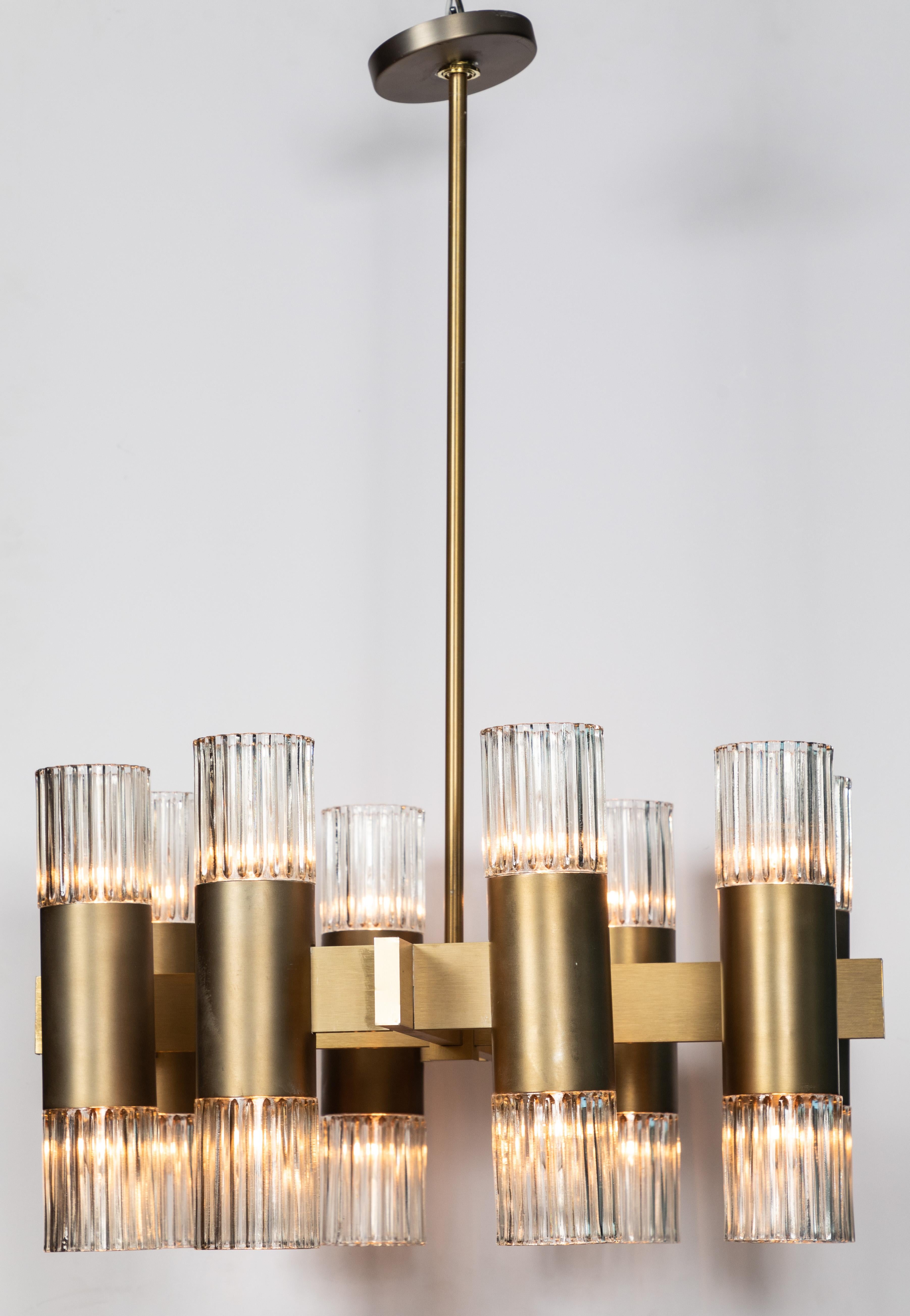 Simple and sleek 16 light ceiling fixture in an brushed brass finished ribbed glass globes. The fixture is designed with 8 upward lights and 8 downward lights. The fixture measures 13