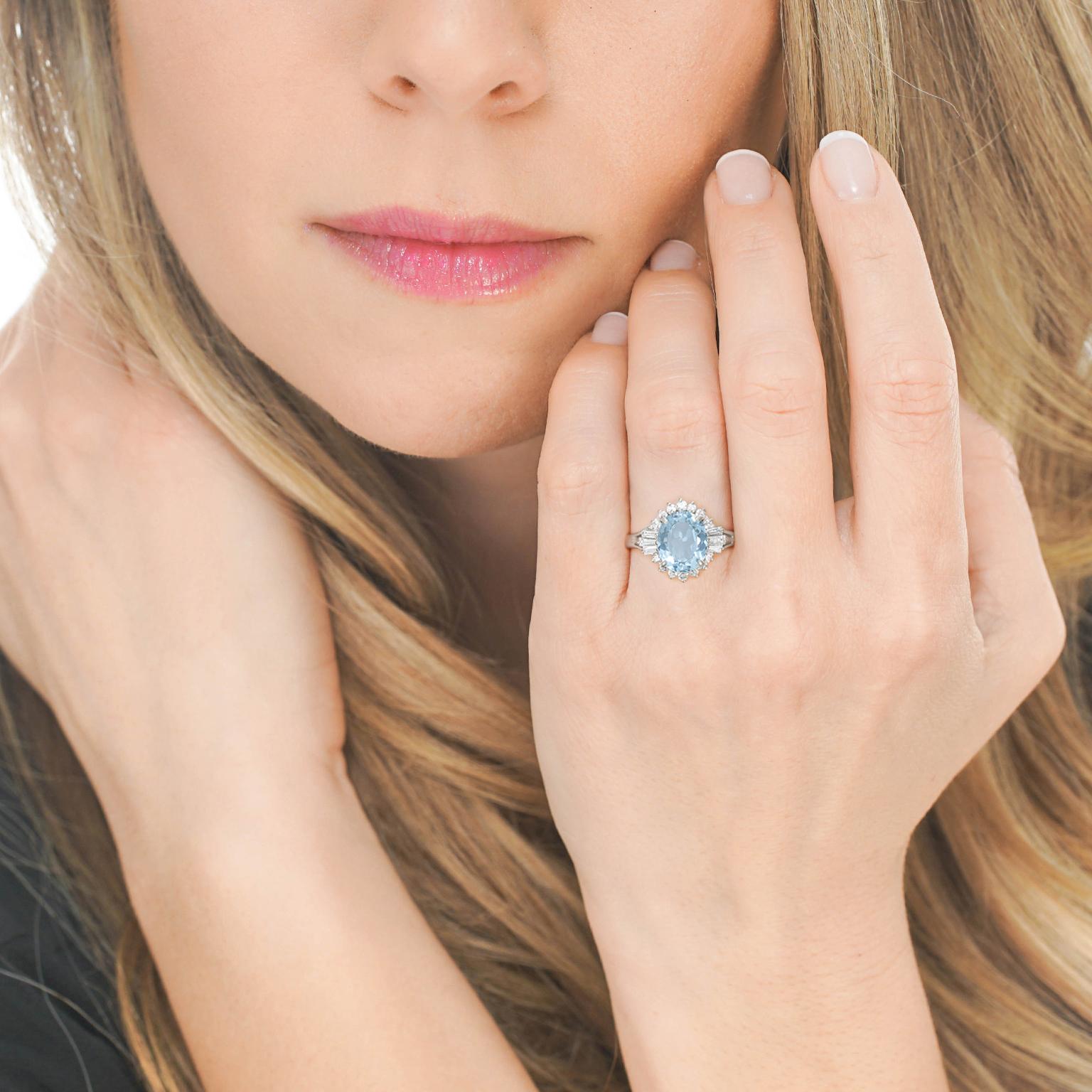 Circa 1960s, Platinum, American. Set with a gorgeous 4.57 carat vivid blue aquamarine accented by .45 carats of brilliant white diamonds (G color, SI1 clarity), this posh ring is vintage chic at its retro sixties best. Finely fashioned in platinum,
