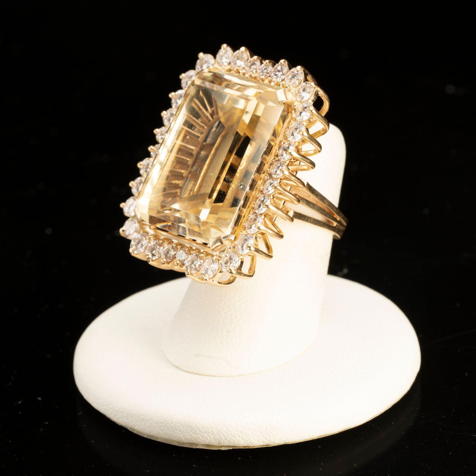 This huge cushion cut sixty carat citrine is surrounded on all sides by 3.25 carats of dazzling white diamonds. Set in 14 karat yellow gold, this is a truly unforgettable custom designed piece that will spark conversation wherever you wear it and is