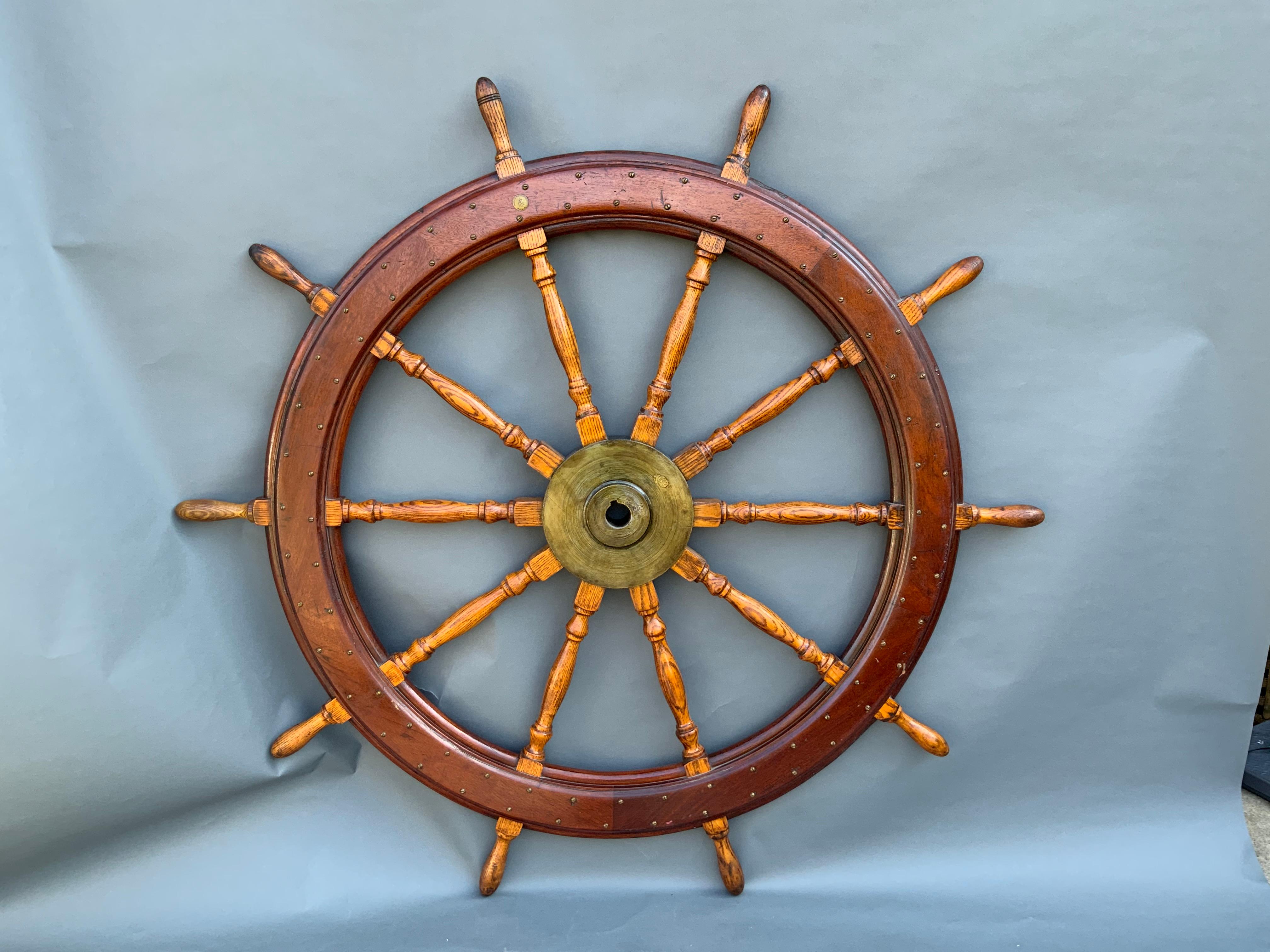 Large ten spoke ship's wheel by American Engineering Company of Philadelphia. Solid brass hub and maker's badge. The outer rings are fastened with dozens of round head brass screws. Varnish finish.

Overall dimensions: Weight is 100 pounds. Diameter