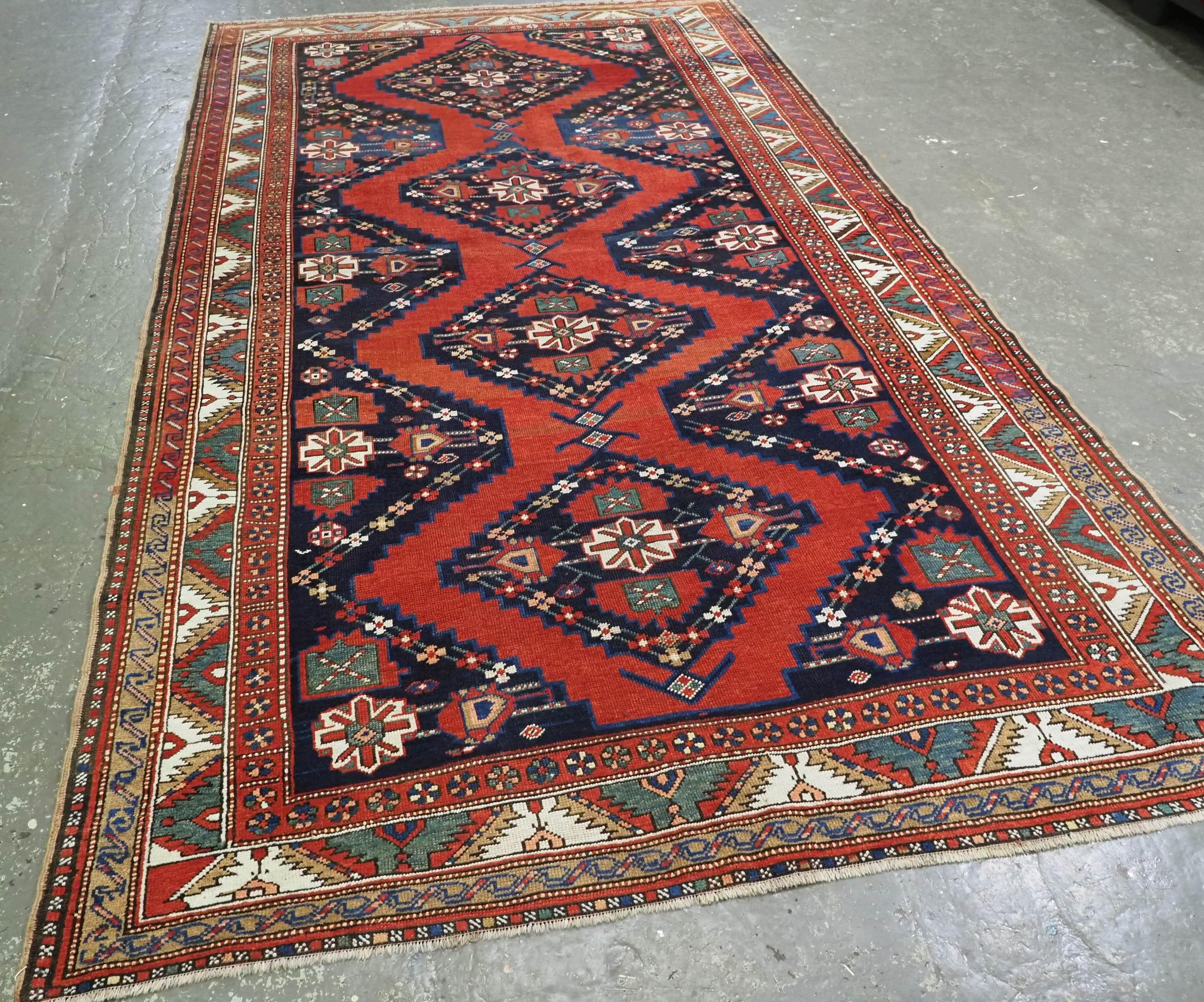 
Size: 10ft 7in x 6ft 0in (323 x 183cm).

Antique South Caucasian Karabagh Kazak kelleh or long rug..

Circa 1900.

The rug has a traditional Karabagh region design of four medallions on a red ground; the medallions and surrounding area are in dark