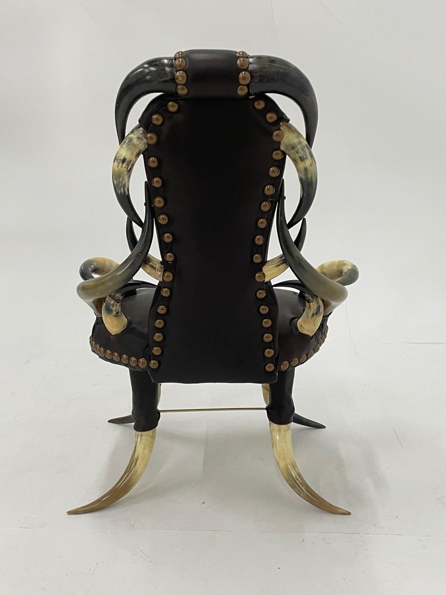 Incredible and a bit naughty blend of black and cream horn and sexy black leather late Victorian armchair recently reupholstered and finished with oversized French oiled bronze nailheads. A piece of art and beautiful from every angle.