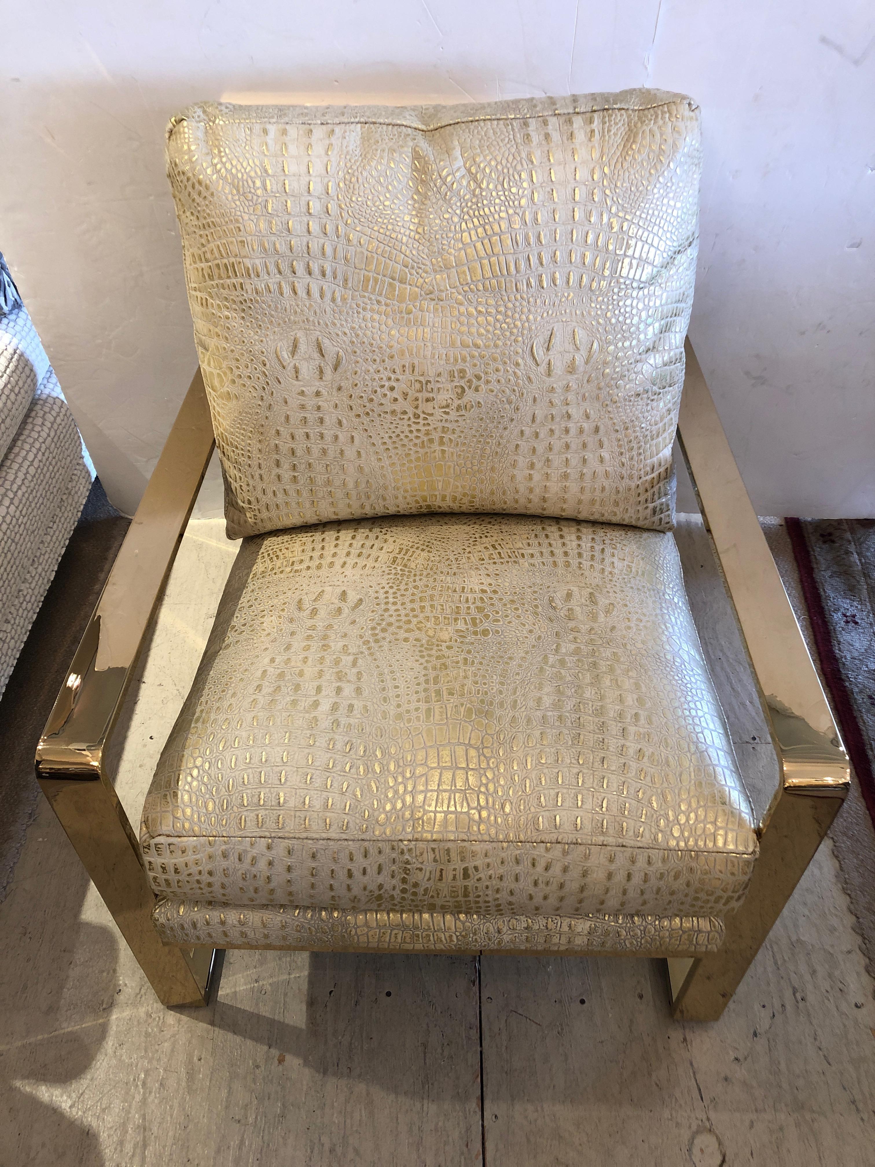 A show stealer glamour chair having chunky brass frame and sensational faux crocodile metallic upholstery that shimmers in cream and gold.
Measures: Arm height 22.5
Seat depth 18.5.