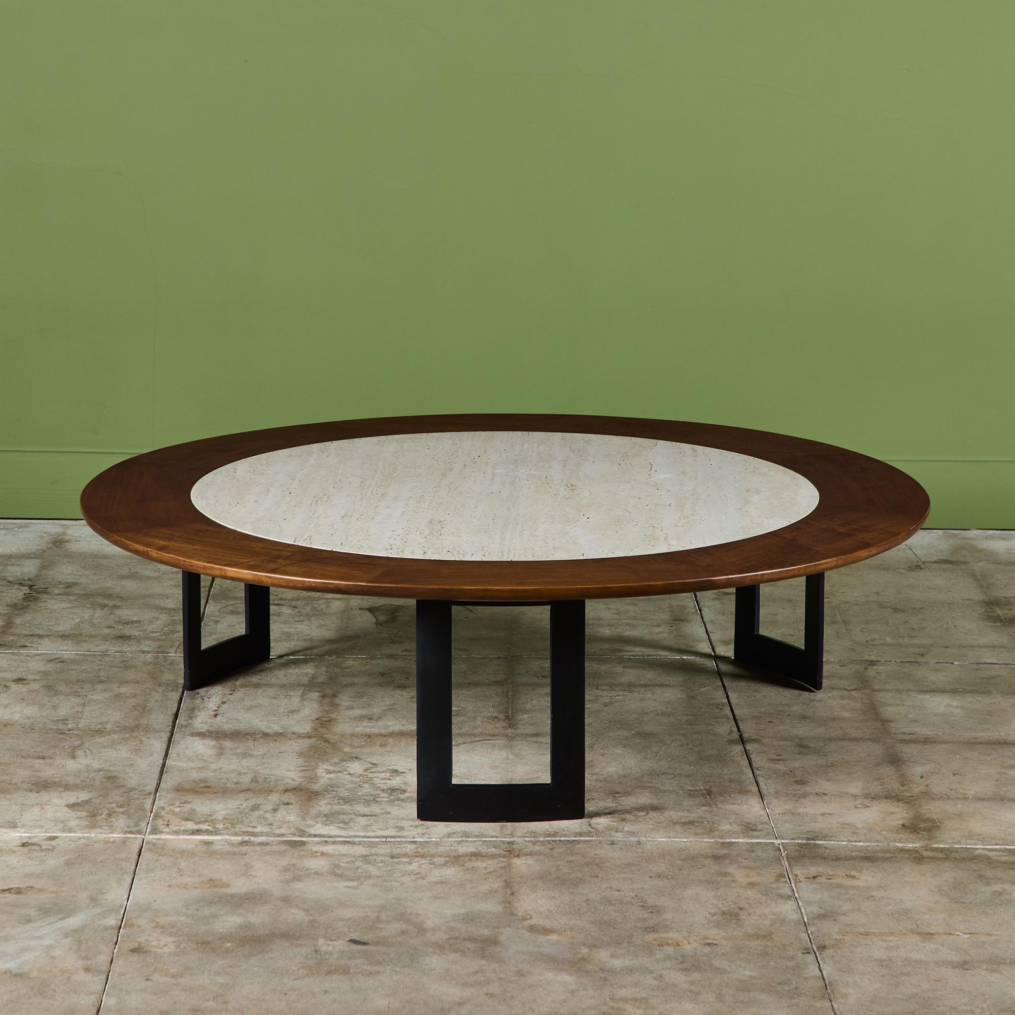 Round coffee table for SJ Campbell Company c.1970s, USA. The table features a walnut frame with an inset travertine top. The table is supported by three 'U' shaped black enameled metal legs.

Dimensions
53.75