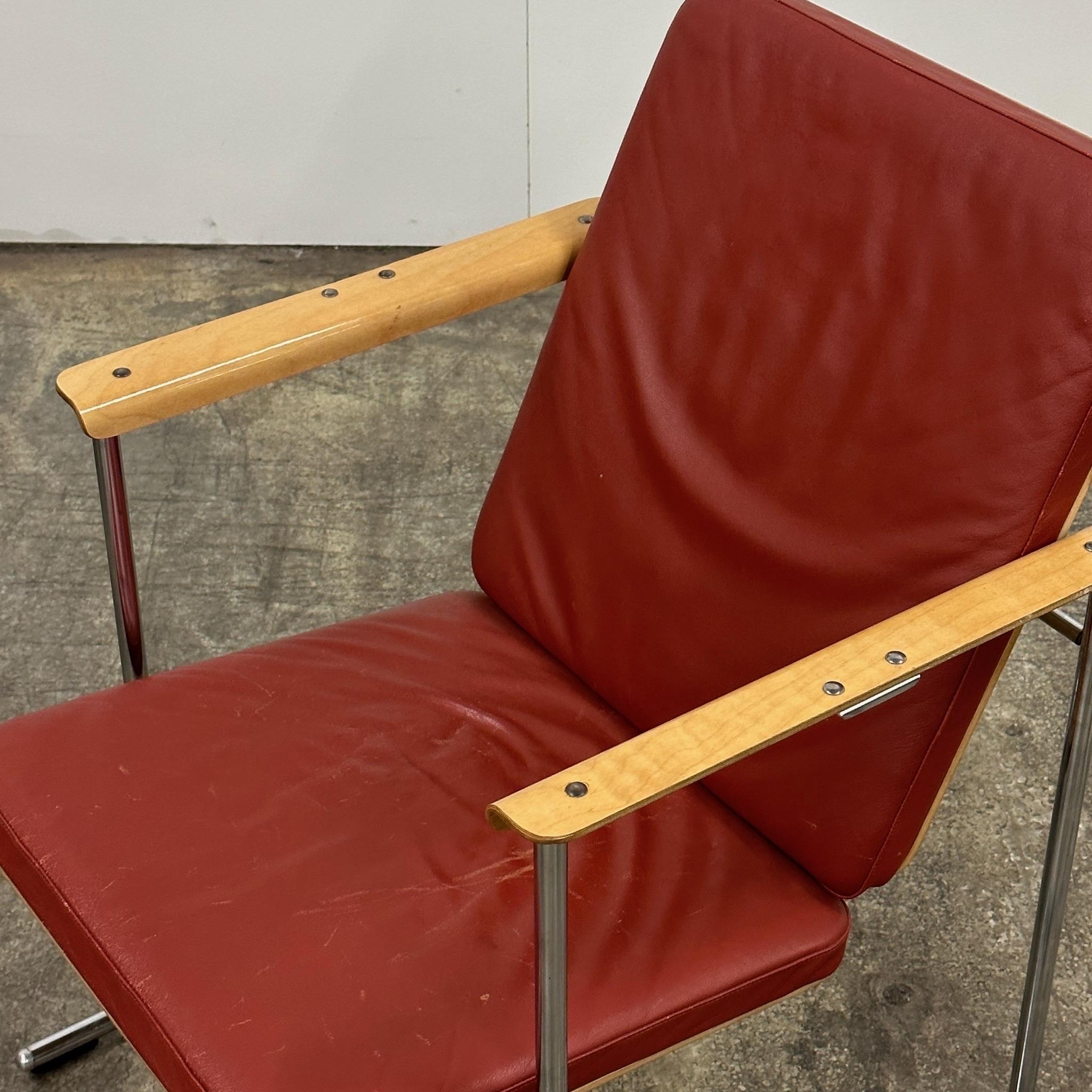 c. 1980s. Made in Finland. Clay leather upholstery with metal frame and wood arms. 