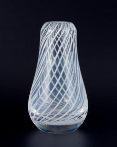 Skandinavian glass artist. Art glass vase in clear glass with white lines