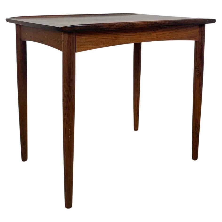A rare Danish coffee table in Rosewood. Made in Denmark during the 1960s. Features a strong wood grain typically for Rosewood and conig legs. The table can be dismanteled for shipping or storage. In very good and original vintage condition.