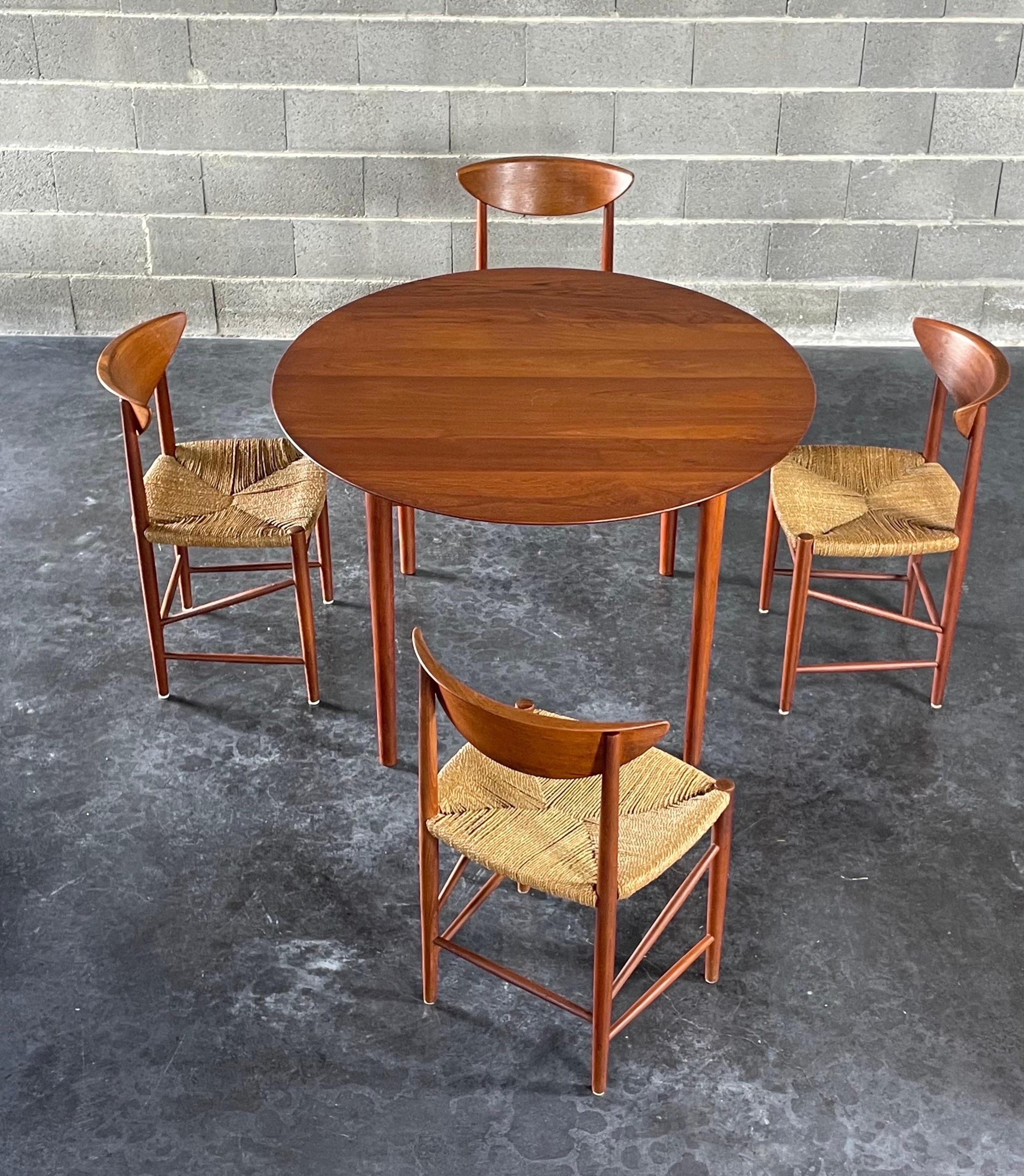 A modular dining table by the iconic Danish designer duo Peter Hvidt and Orla Mølgaard Nielsen. Made in Denmark by France & Søn circa 1950s. The extra leave in the middle easily accommodate guests when needed, revealing a spacious oval-shaped top