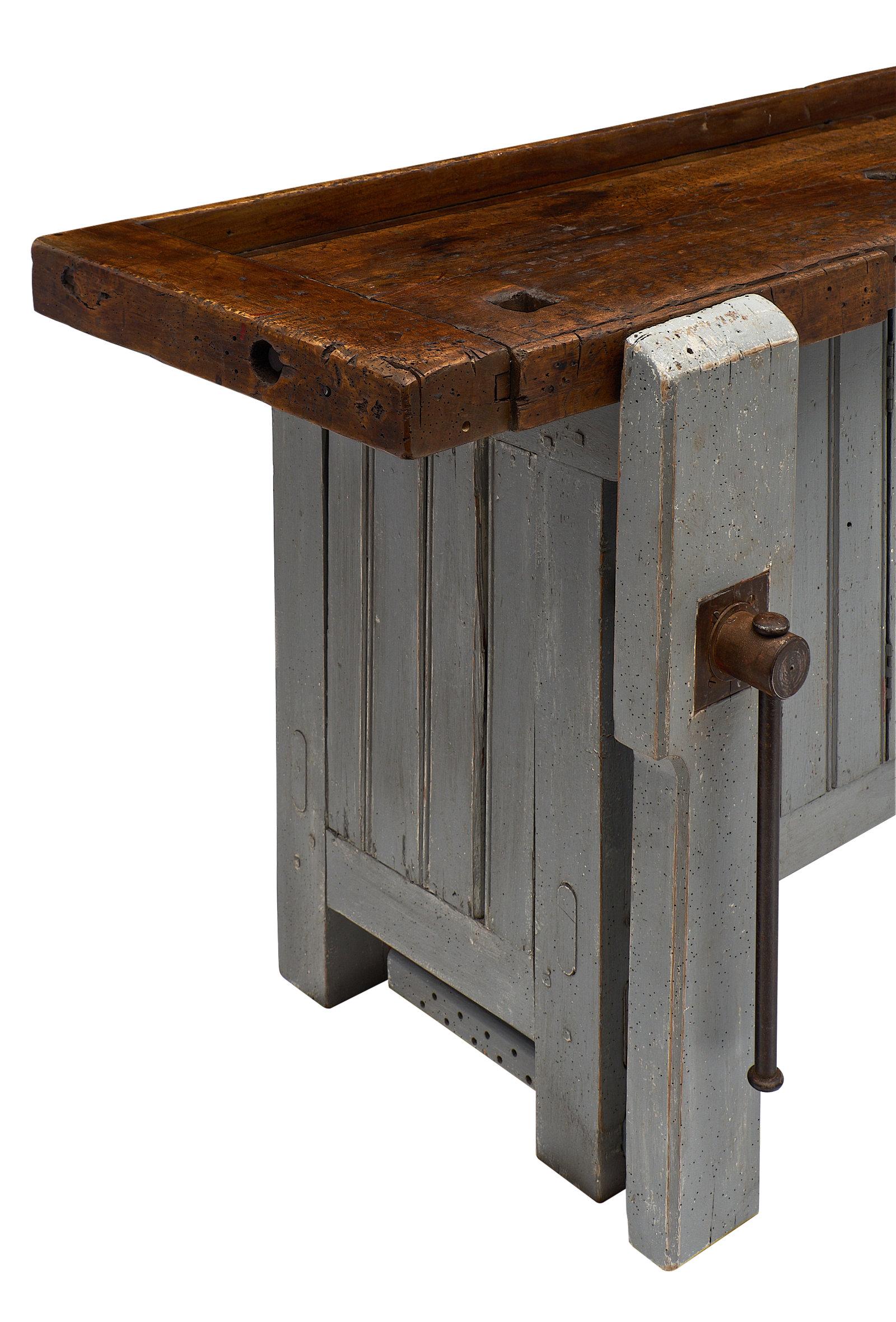 French antique “ski crafting” workbench from the French Alps. We fell in love with this rare ski crafting carpenter workbench made of fir. We couldn’t resist the original painted color, iron vise, and dramatic decorative impact of the piece. There