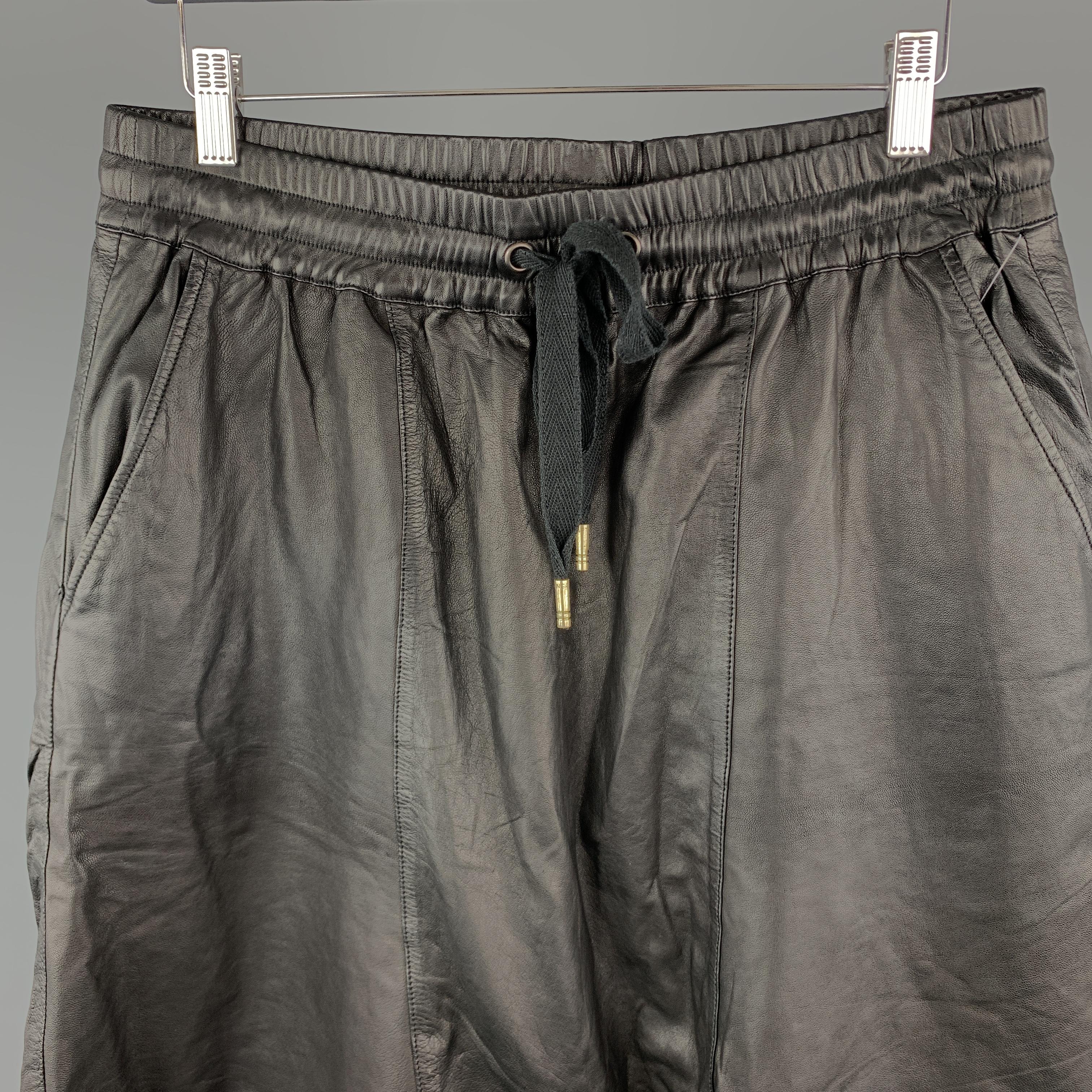 SKINGRAFT Shorts comes in a black tone in a solid leather material, with a drawstring, a drop-crotch, seam and slit pockets. 

Excellent Pre-Owned Condition.
Marked:

Measurements:

Waist: 33 in. 
Rise: 20 in. 
Inseam: 2.5 in. 