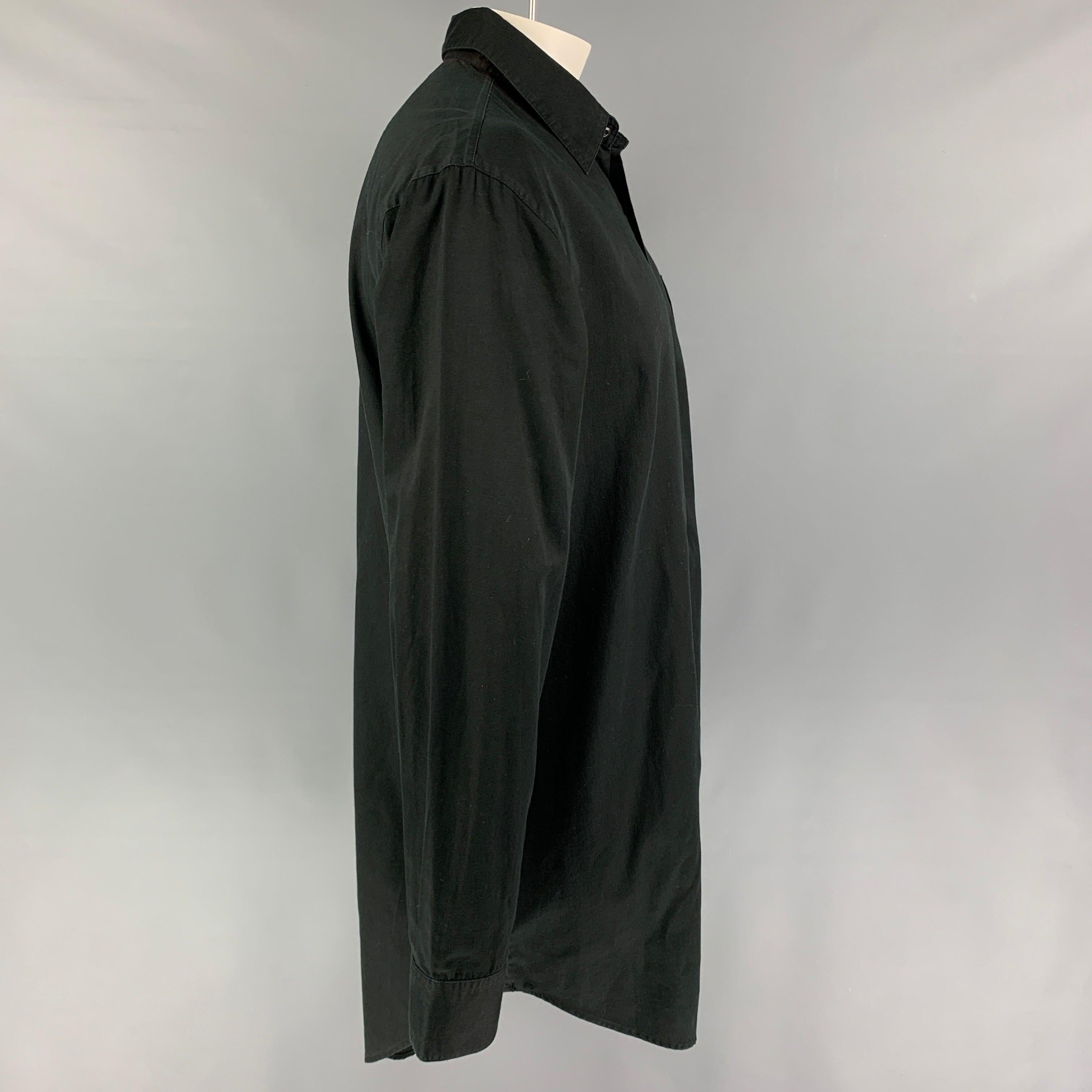 SKINGRAFT long sleeve shirt comes in a black cotton featuring a long length, back buttoned detail, patch pocket, spread collar, ad a button up closure.
Very Good
Pre-Owned Condition. 

Marked:   XL  

Measurements: 
 
Shoulder:
21.5 inches  Chest: