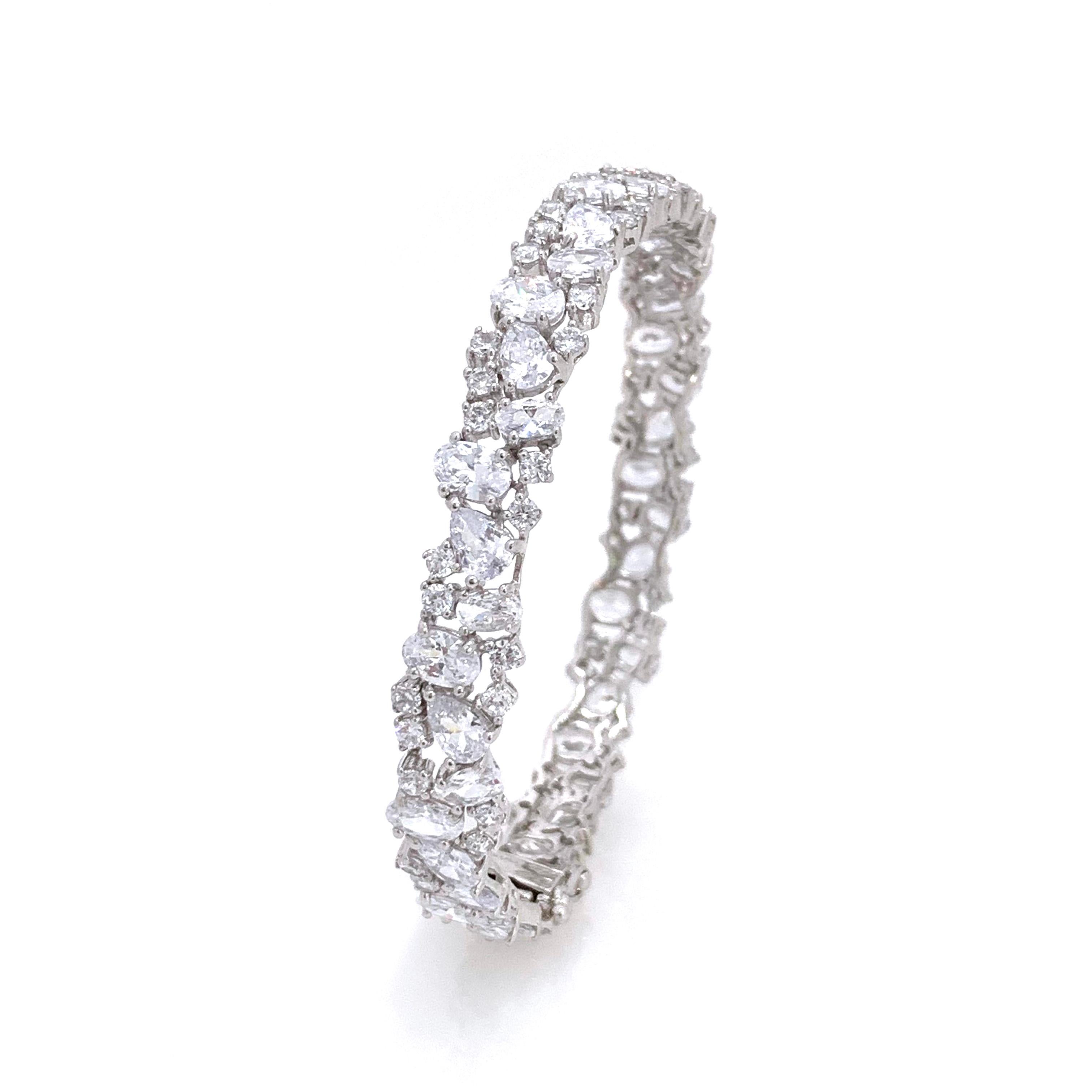 Fabulous Skinny All-around Encrusted Faux Diamond Sterling Silver Bracelet. This bracelet features over 100 pcs of various shape of faux diamond cubic zirconia (AAA quality), handset on platinum rhodium plated sterling silver.  Push clasp closure
