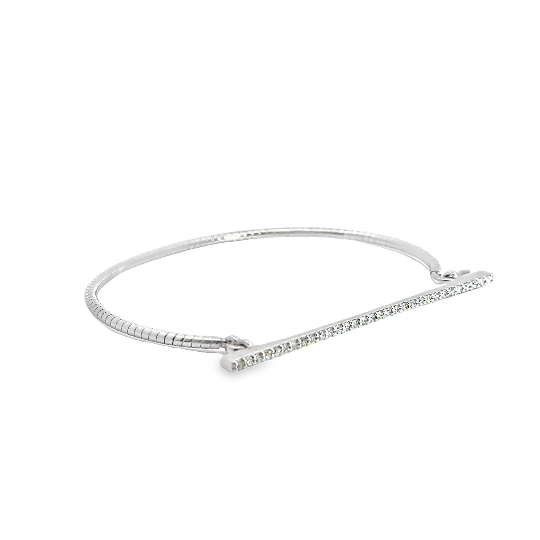Grace your wrist with this finely crafted work of jewelery art. Crafted from the rarest of 18 karat white gold, this bangle has been meticulously designed into a timeless and elegant silhouette. Wrapping your wrist in luxury, the white gold gleams