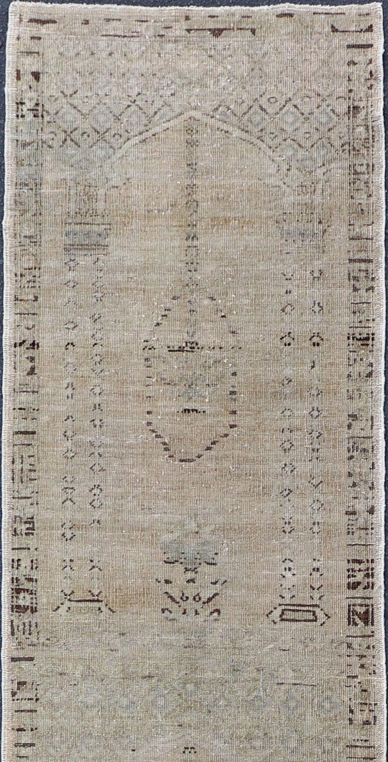 Distressed Turkish long and narrow runner with floral design and neutral colors. 
Rug/EN-94027, 1940 vintage Oushak runner

Measures:2'5 x 17'3

This vintage Turkish Oushak long and narrow runner has been neutralized to create faded pigments