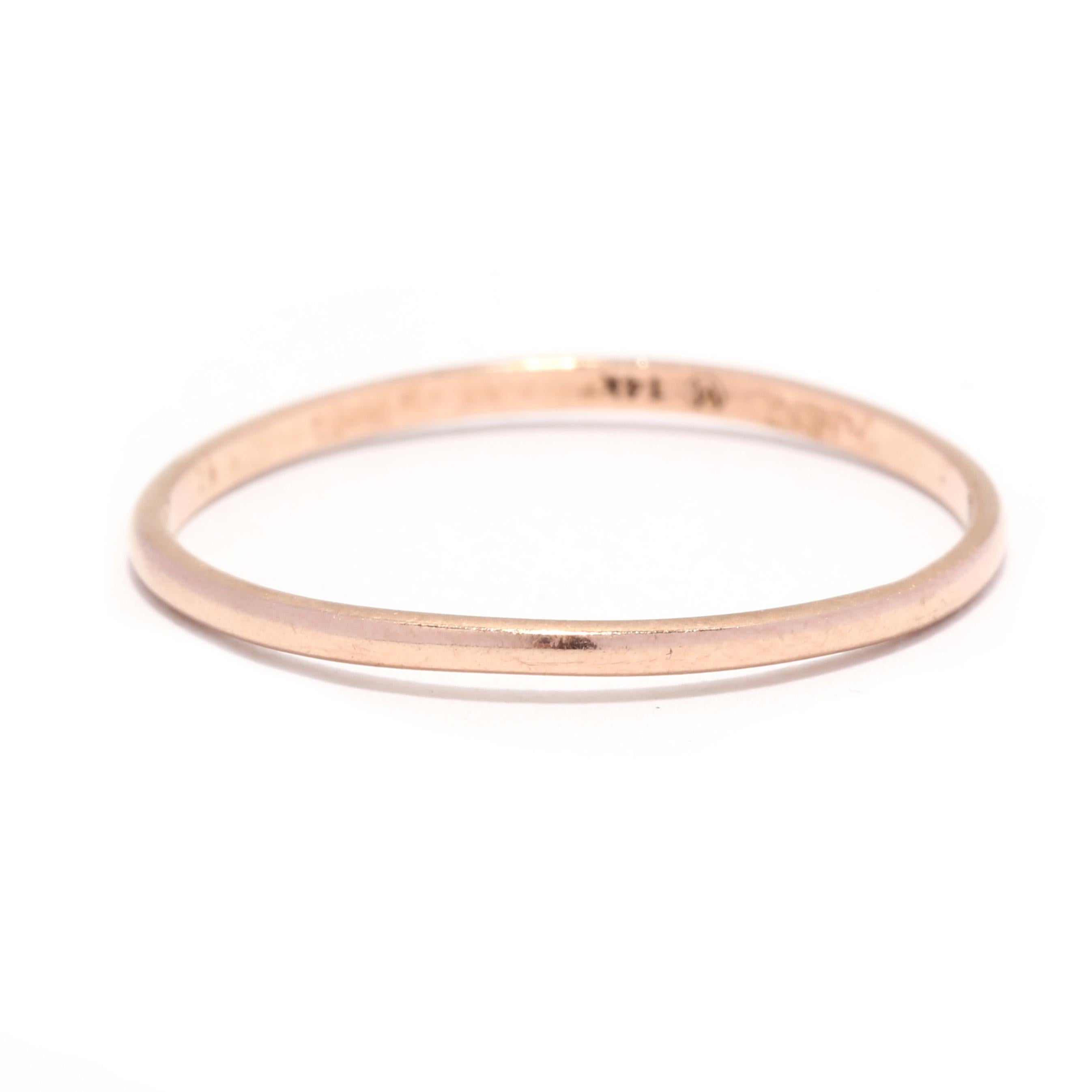 A 14 karat rose gold skinny band ring. This ring features a slightly domed, thin stackable band design.

Ring Size 8

Rise Off Of Finger: 1 mm

Width: 1.3 mm

Weight: .5 dwts. / .7 grams

Stamps: 14K

Ring Sizings & Modifications:
* We are happy to