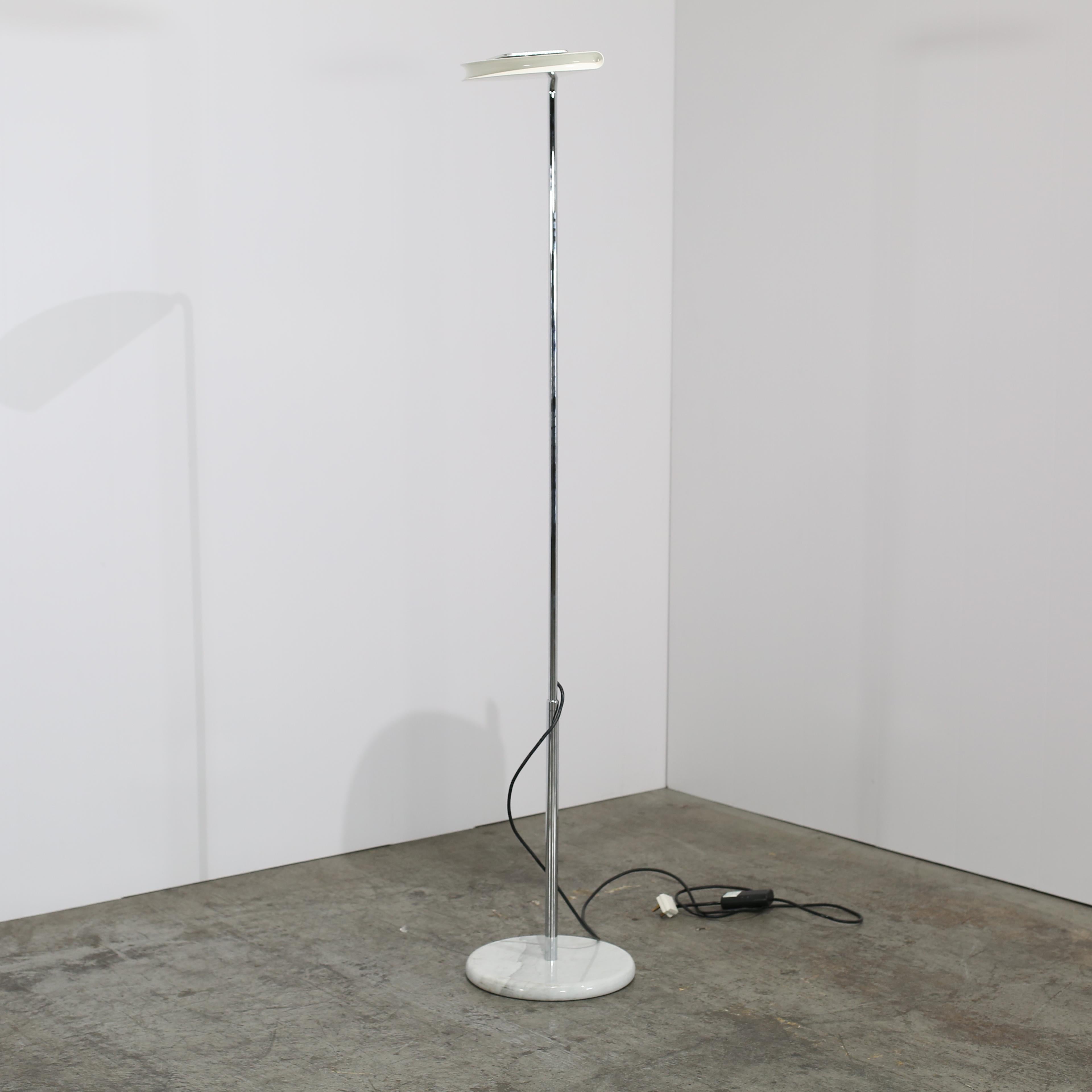 Add a touch of retro elegance to your living space with the Mezzaluna floor lamp by Bruno Gecchelin for Skipper and Pollux, crafted in the 1970s. This iconic piece features a sleek design with a polished metallic look, making it a statement piece in