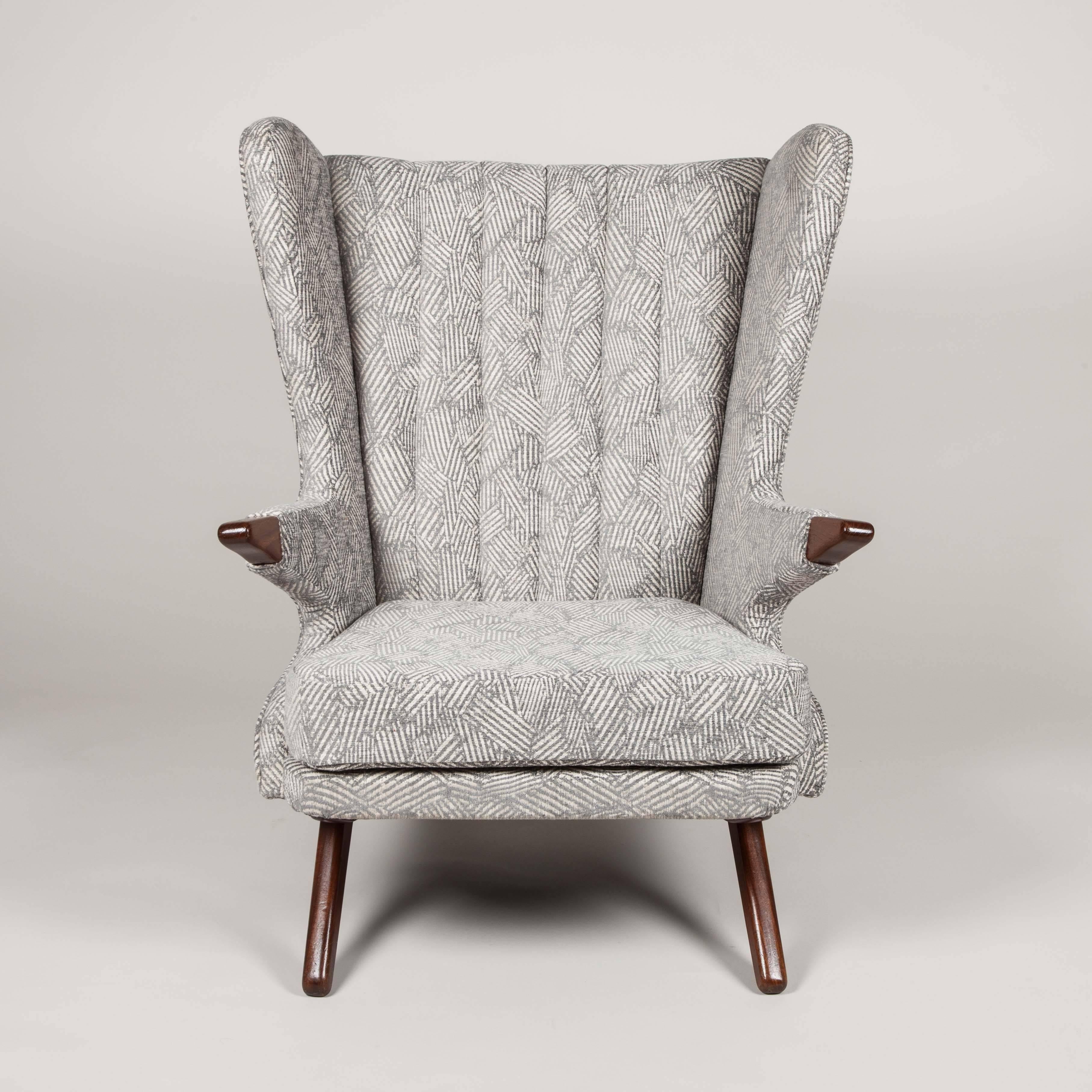 A wingback easy chair with teak legs and arms, design attributed to Svend Skipper.



 