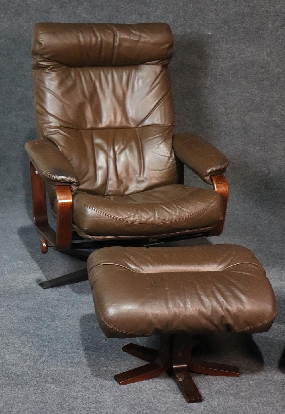 Measures: 41 tall x 31 wide, 30 deep, seat 19 inches

Ottomans 16 tall x 24 wide x 16 deep

This is a gorgeous pair of brown leather Danish modern reclining chairs. The leather is distessed from age but is actually in fairly good condition! They