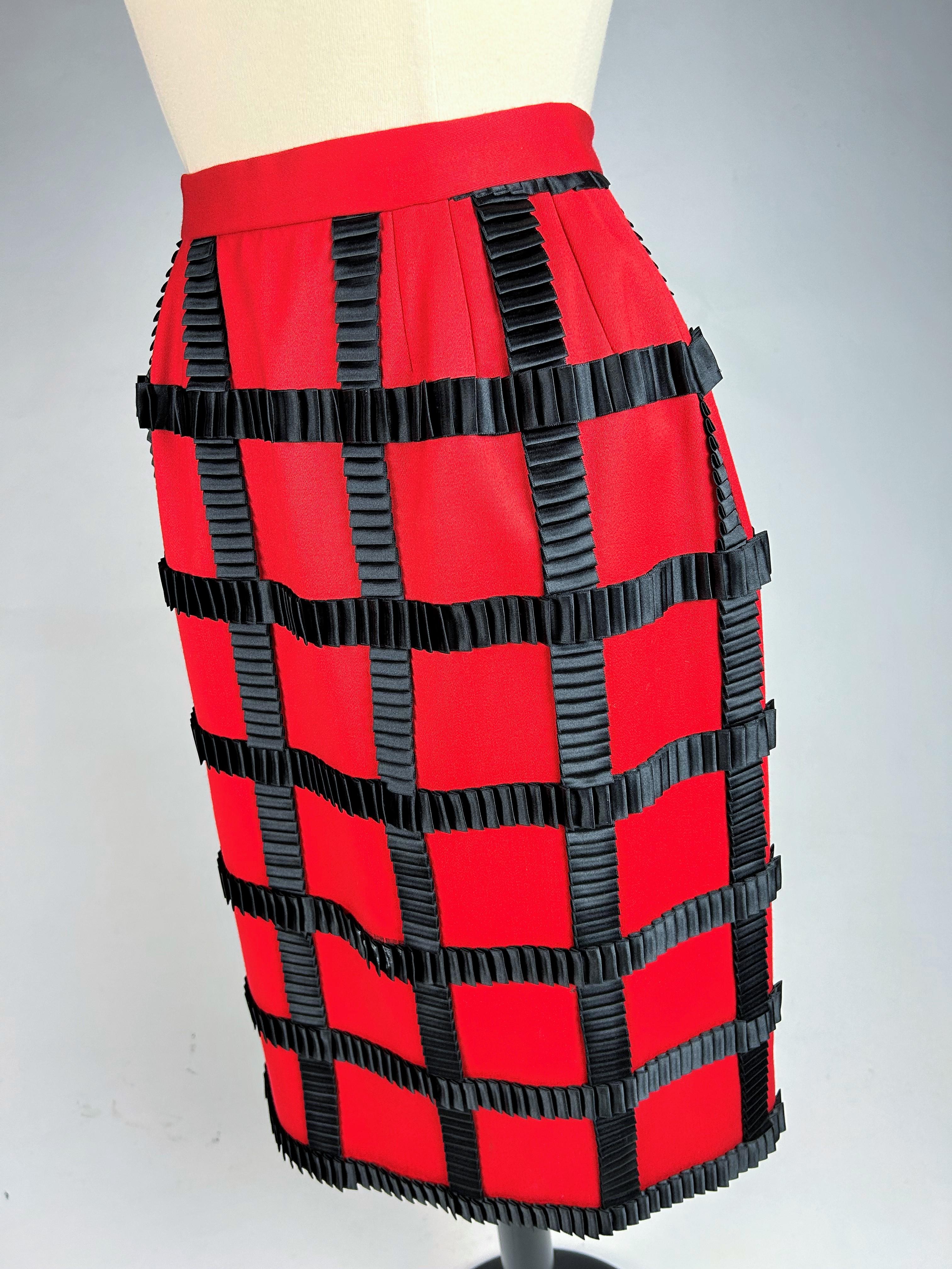 Spring Summer 1989 Collection

France

Beautiful skirt in scarlet red wool cloth with a checkerboard of pleated ribbons in black satin by Paco Rabanne, look 19. Fitted skirt with flat pleats mounted on a waist belt and slit at the back. Elegant