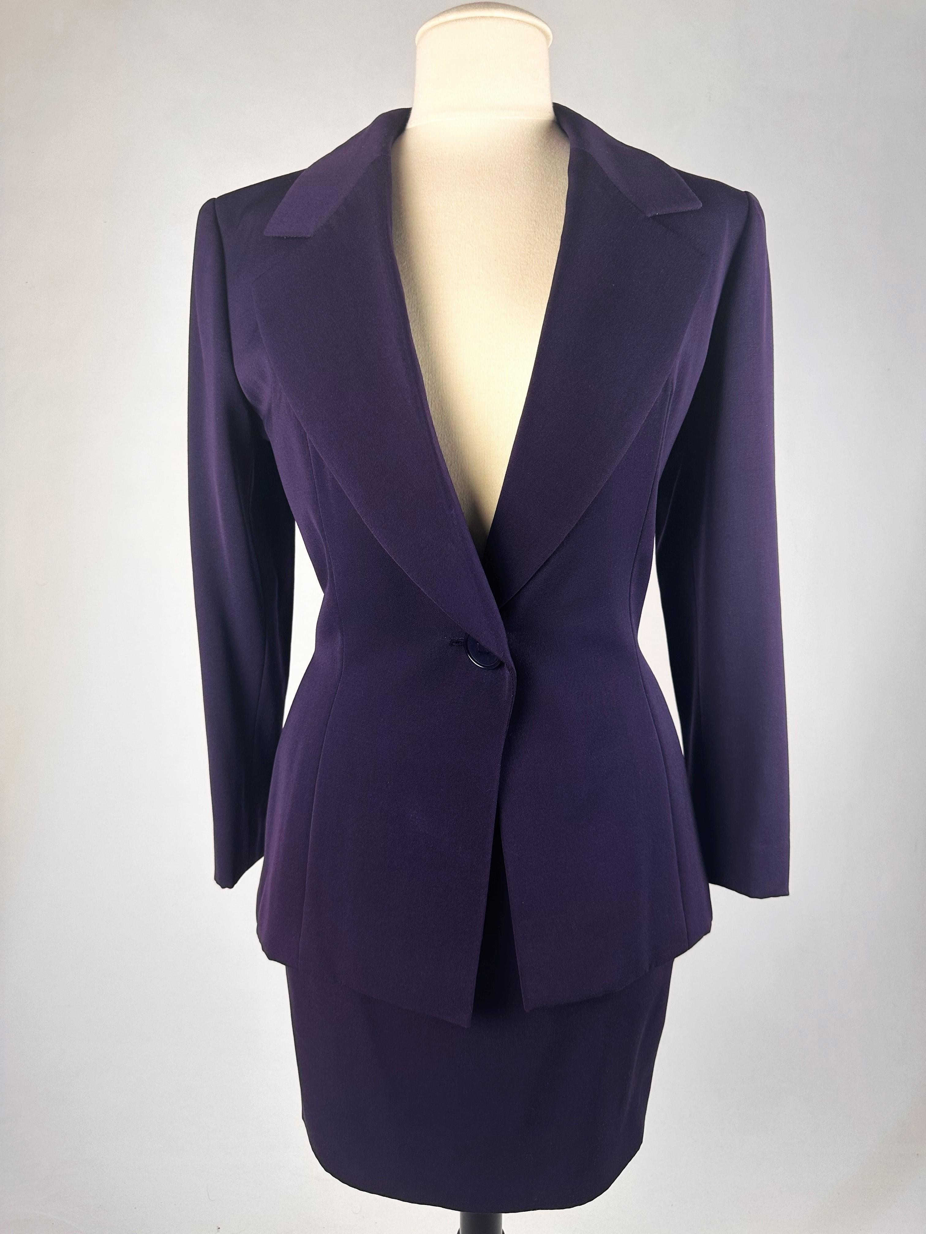 Circa 1990-1995

France

Haute couture skirt suit by Gianfranco Ferré for Christian Dior dating from the 1990s. Tuxedo jacket and fitted skirt in cardinal purple wool twill. Hip-length fitted jacket with large shawl collar closed and crossed at the