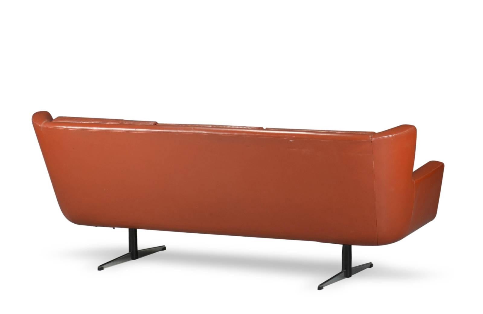 Skjold Sørensen. Three-seat sofa with removable cushions on chromed Shaker steel frame, covered with brown leather buttoned. L. 205 cm. H. 80 cm. Seat height: 45 cm. Traces of wear and patina of the leather.