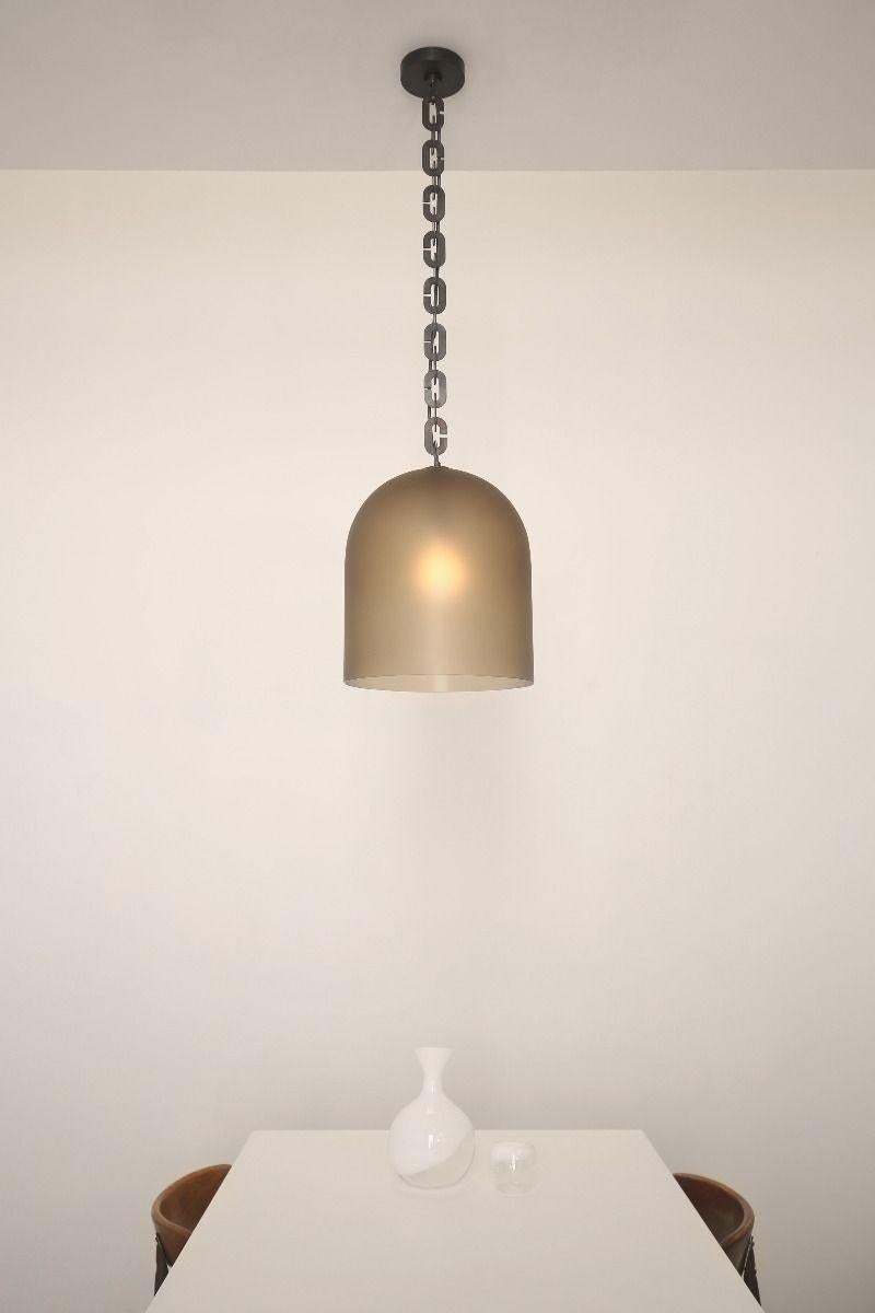 Large domes of hand blown Czech glass with a frosted finish are suspended on lengths of oversized brass chains. An exposed fabric-wrapped electrical cord runs through the chain from canopy to light.

Made in the Czech Republic

DIMENSIONS
17''