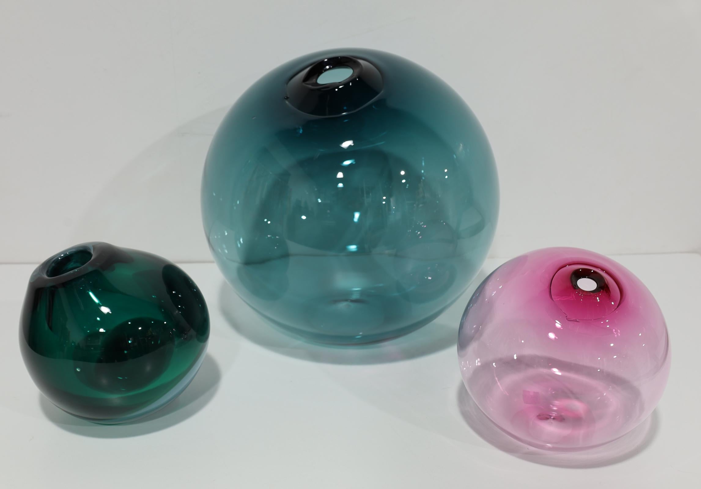 Organic spheres of handblown Czech glass with broken flame polished mouths. They are entirely free‑blown, produced without the use of moulds to shape them. The tops are given a slight ripple where they are dipped twice into the molten glass, and the
