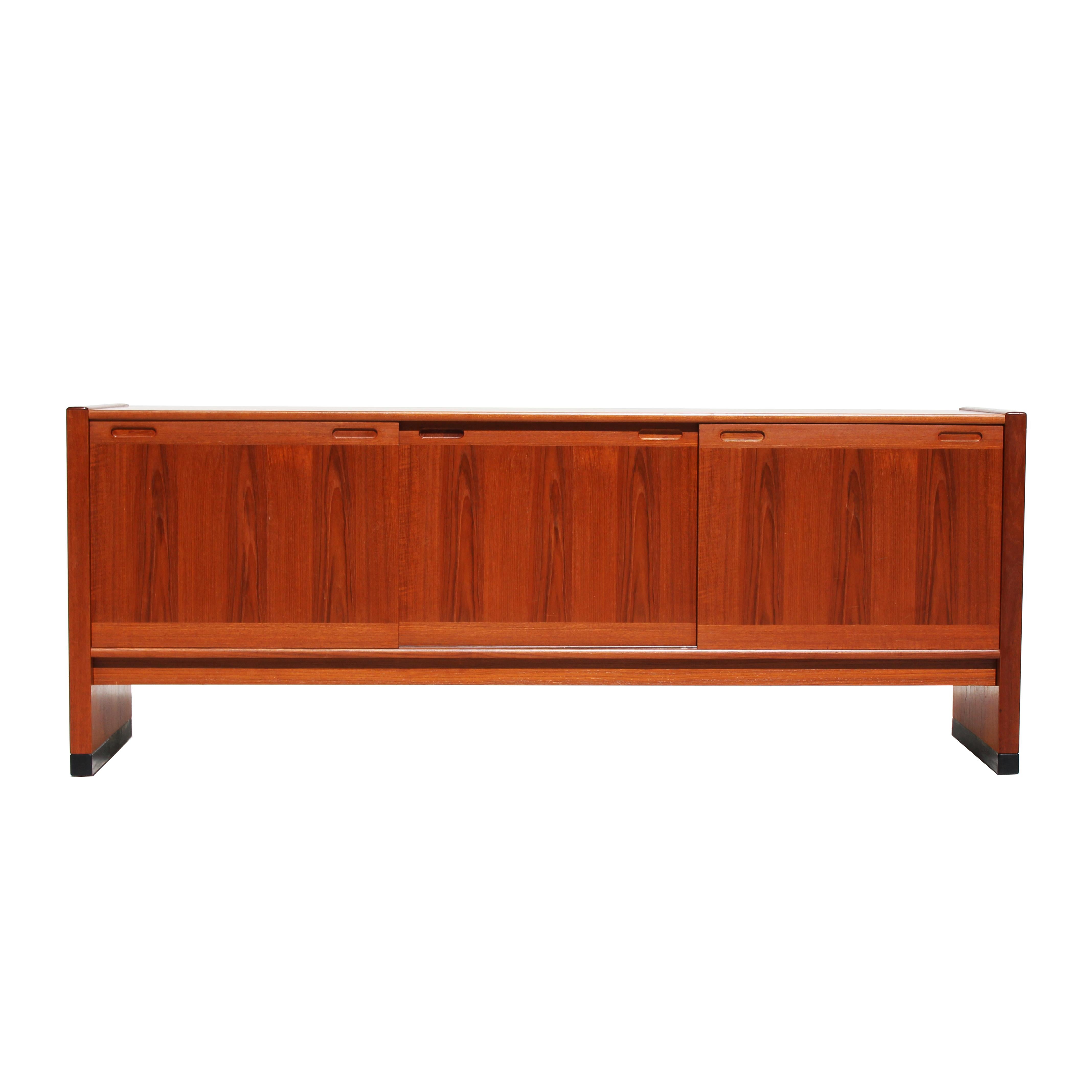 SKovby Rosewood sideboard with three sliding doors. Adjustable shelves and two silverware drawers inside. 

The sideboard is in good condition. However it can be restored professionally to a vintage condition. The piece is restored upon purchase so