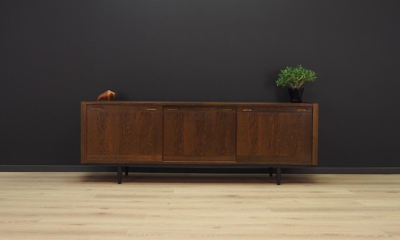 Classic sideboard from the 1960s-1970s, a minimalistic form finished with oak veneer straight from the Skovby manufacture. Roomy interior with sliding shelves. Preserved in good condition (small bruises and scratches, filled veneer loss) - directly