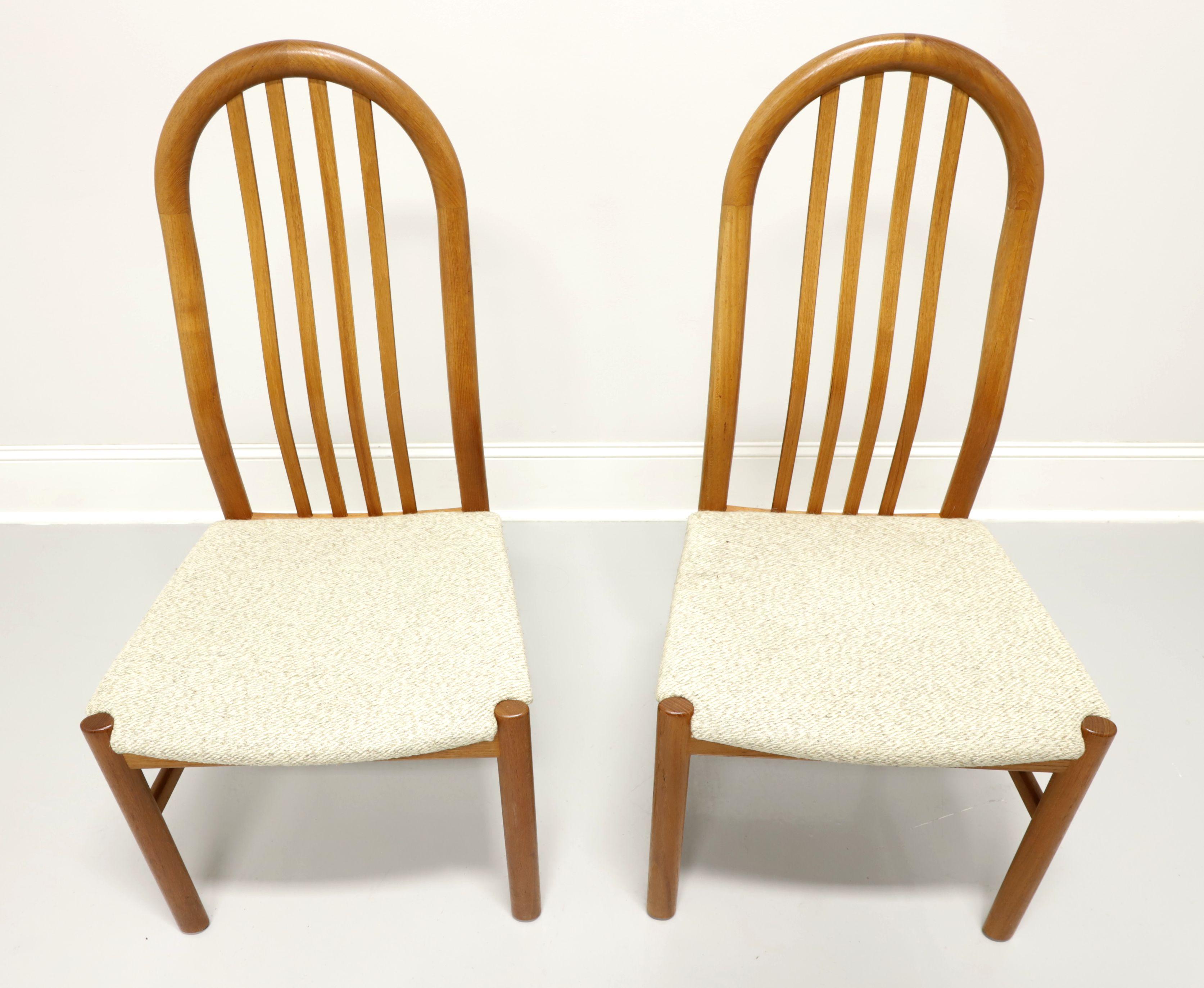 A pair of dining side chairs in the Danish Modern style by Skovby. Teak with arched crestrail, slat back, neutral color tweed like fabric upholstered seat and round straight legs with side stretchers. Made in Denmark, in the the mid-20th