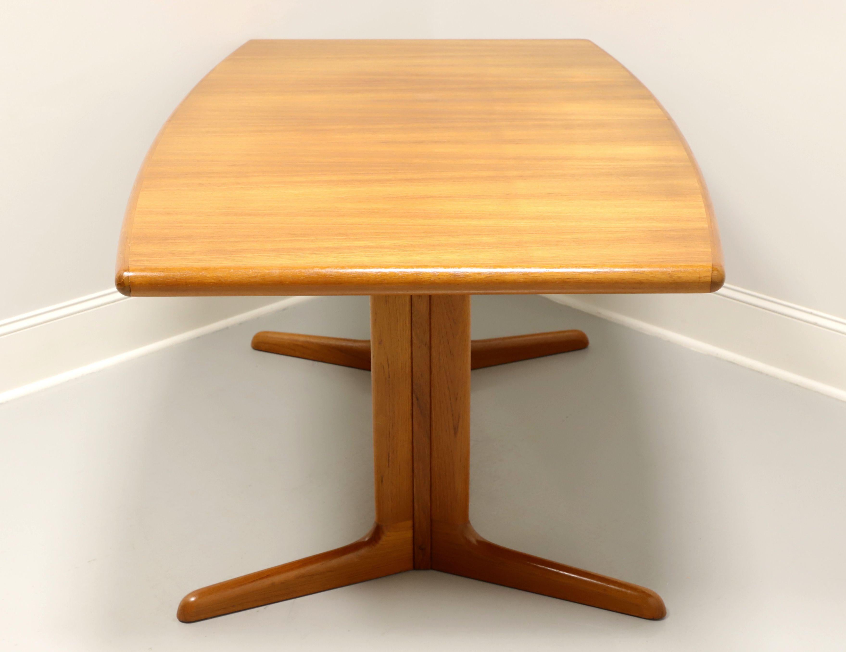 A tapered rectangular shaped dining table in the Danish Modern style by Skovby. Teak with a stunning grain to the top, banded edge, smooth rounded apron and trestle style base. Includes two extension leaves for placement on wood expansion sliders. 