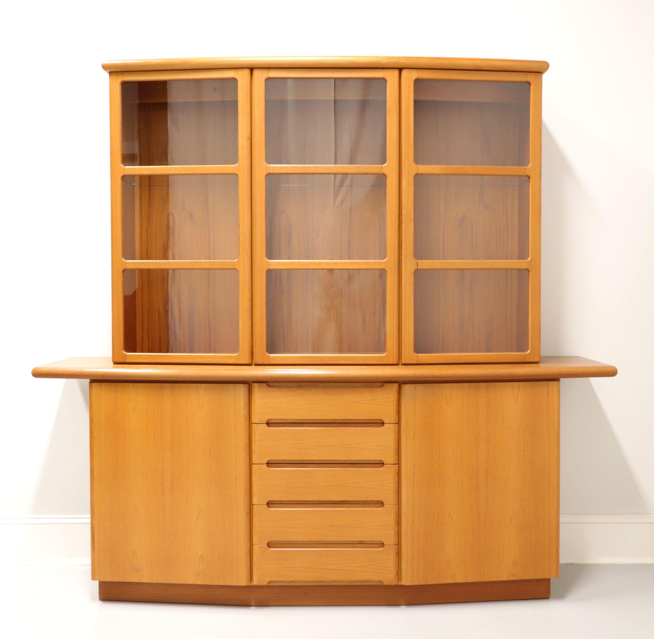 A Danish Modern style bowfront china cabinet by Skovby. Teak and oak, three 3-pane glass upper doors, rounded top and front. Upper lighted cabinet features three compartments with two adjustable glass shelves in each. Lower cabinet features five