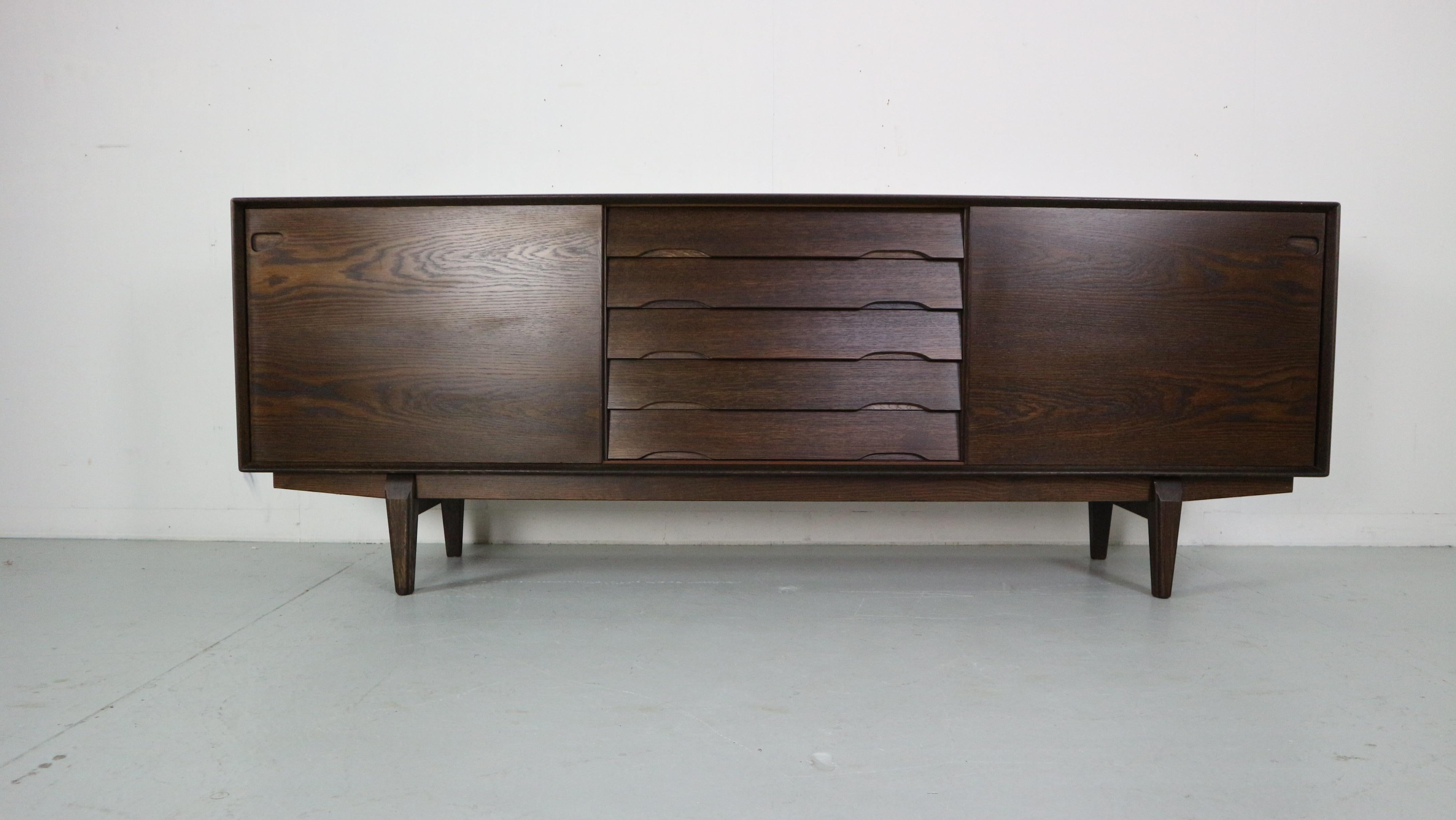 Mid- Century modern period unique shaped sideboard produced by Skovby Møbelfabrik in 1960's period, Denmark.

Model No- 65. Originally marked of the back of the sideboard.

Made of darkened solid oak. Beautiful wooden patina all around the