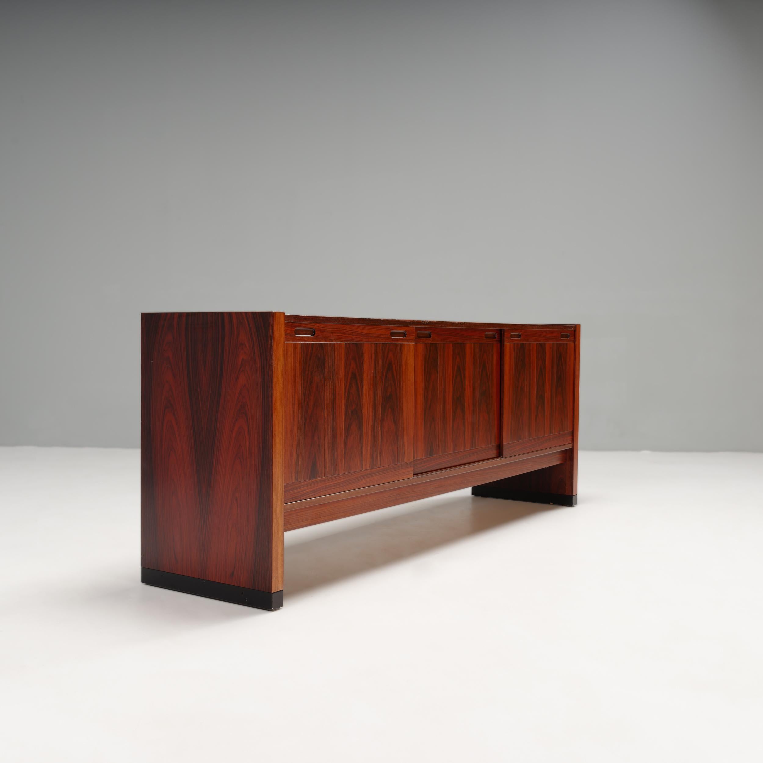 A fantastic example of Danish Mid-Century Modern design, this sideboard was made by renowned cabinet manufacturer Skovby.

Constructed from rosewood, the sideboard has a sleek, Minimalist aesthetic, making it ideal for displaying items along the