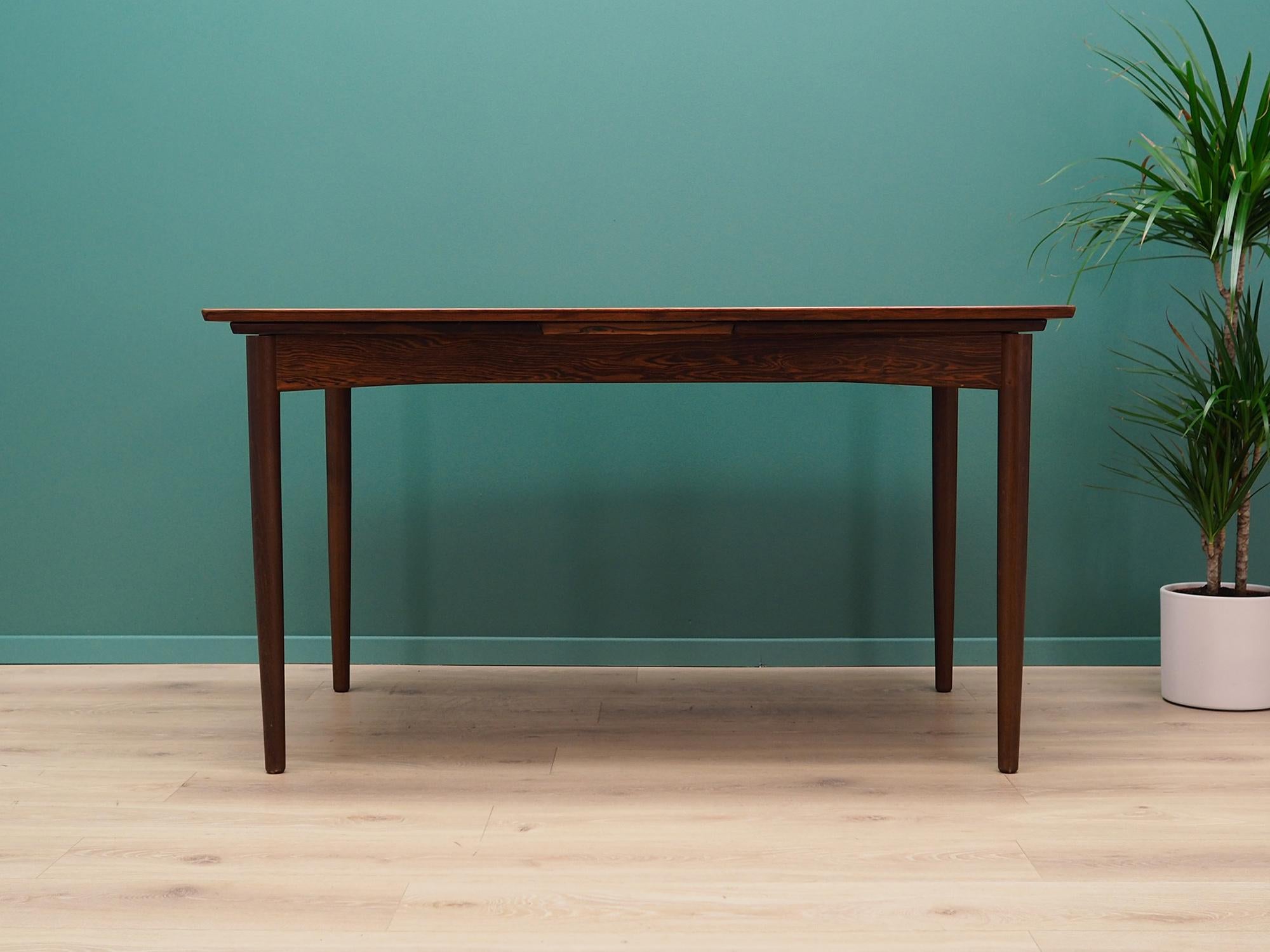 Great table from the 1960s-1970s. Scandinavian design, Minimalist form. Manufactured by the Skovby. tabletop finished with rosewood veneer. Construction made of solid rosewood. The table has two inserts pulled out from under the top. Preserved in