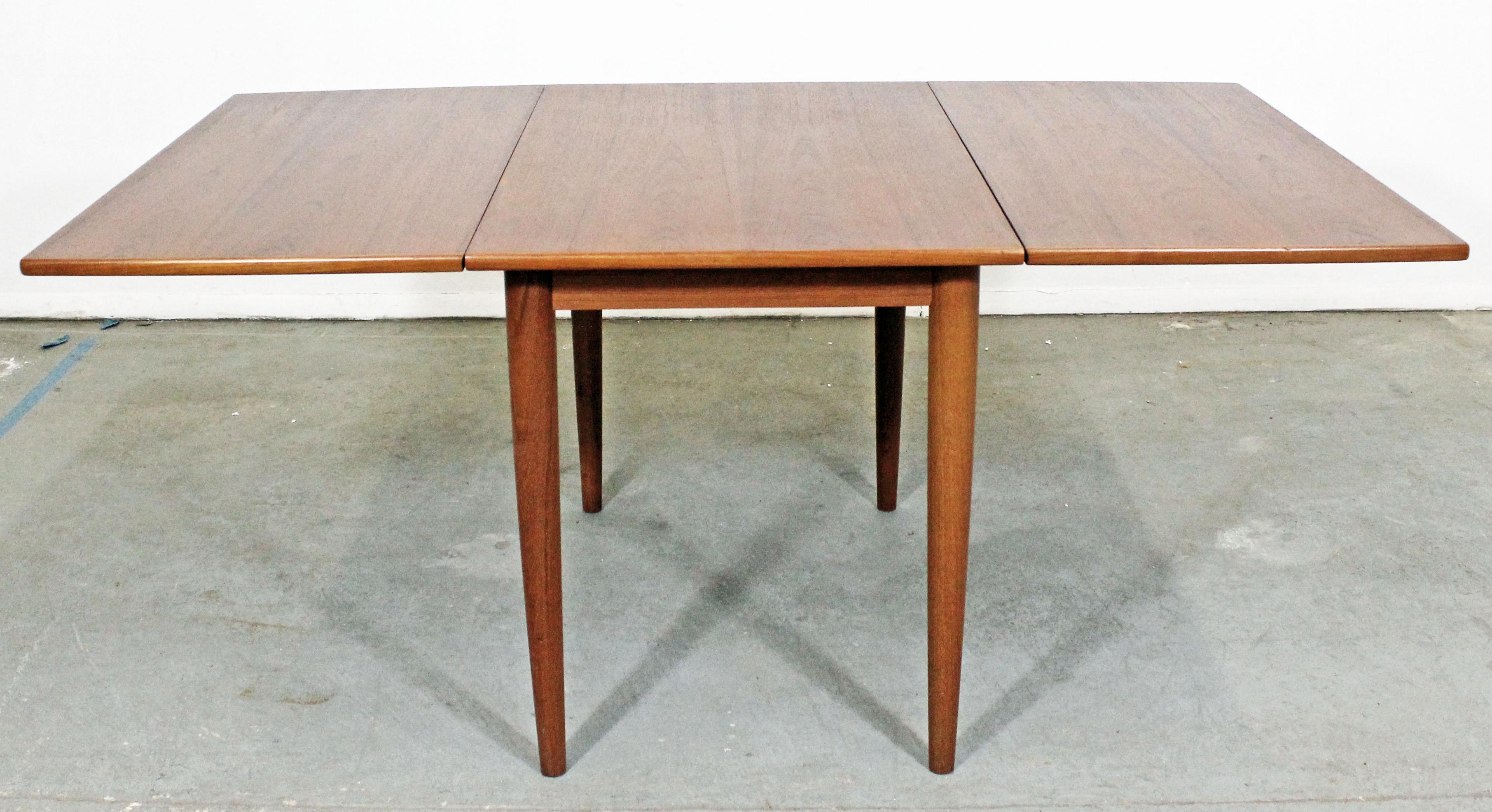 Teak drop-leaf dining table made by Skovmand & Andersen for Moreddi. Has been refinished.

Approximate dimensions:
Fully open: 63.25