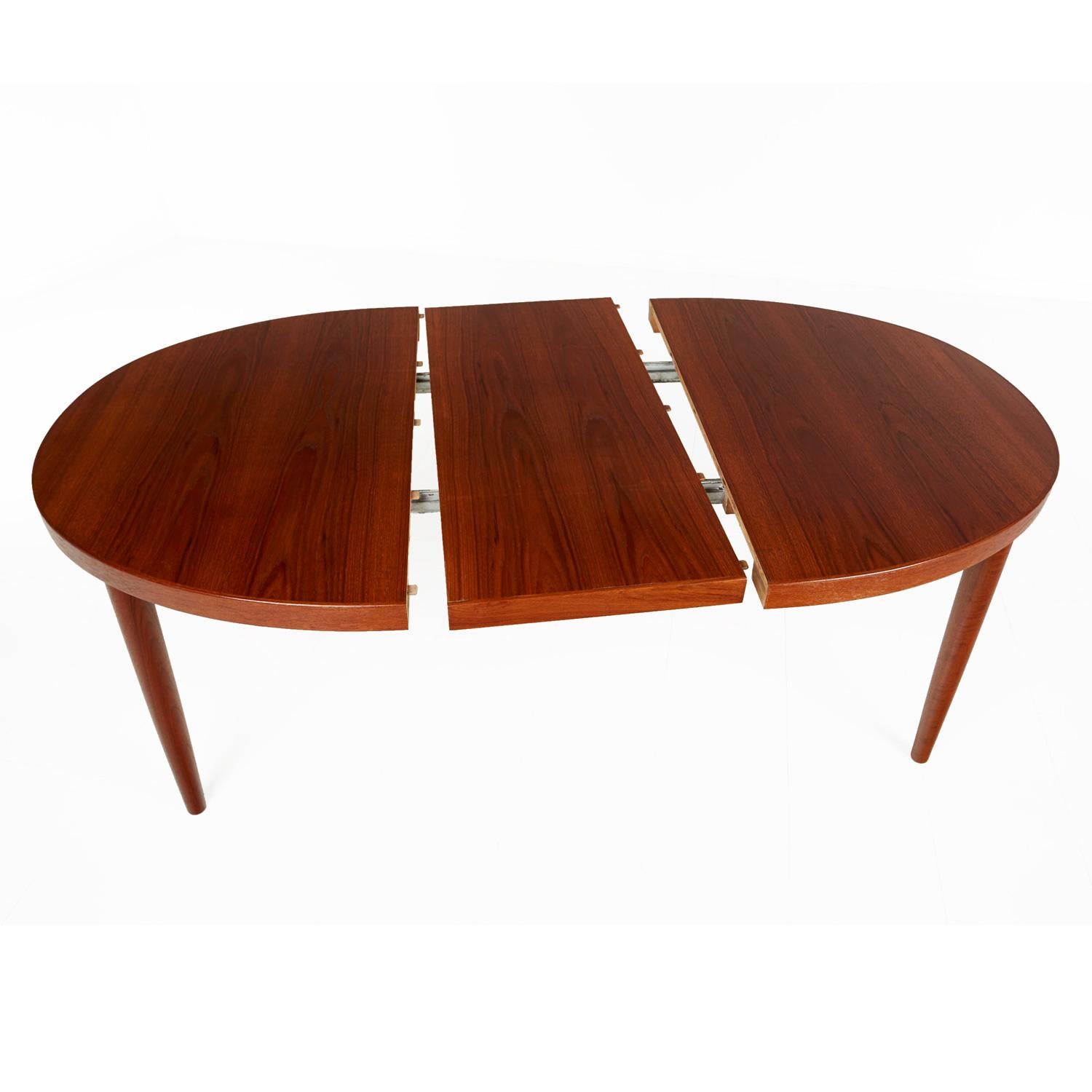 Mid-Century Modern Danish teak dining table by Skovmand Andersen. One of the finest Scandinavian producers of the era. This table bears the maker’s mark and Danish Control stamp. This stamp is reserved for the cream of the crop Danish furniture