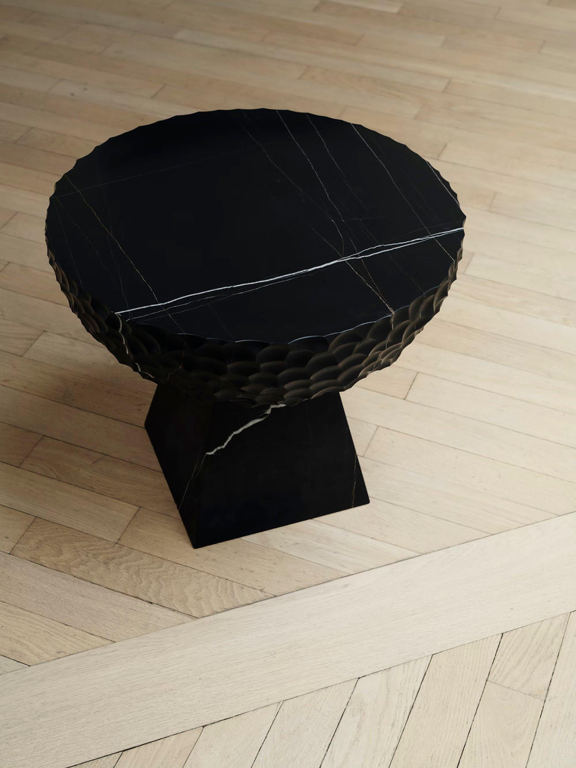 A heavyweight take on the SKS Side Table, the SKS (Small Key Stone Side Table) replicates all of its organic details and hand carved shapes and reframes them in solid Grafite Oro Nera Stone. The mineral’s precise lines and veins add surprising