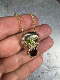 Skull and Soul (14K Yellow Gold, Peridot, and Garnet Pendant) by Ken Fury